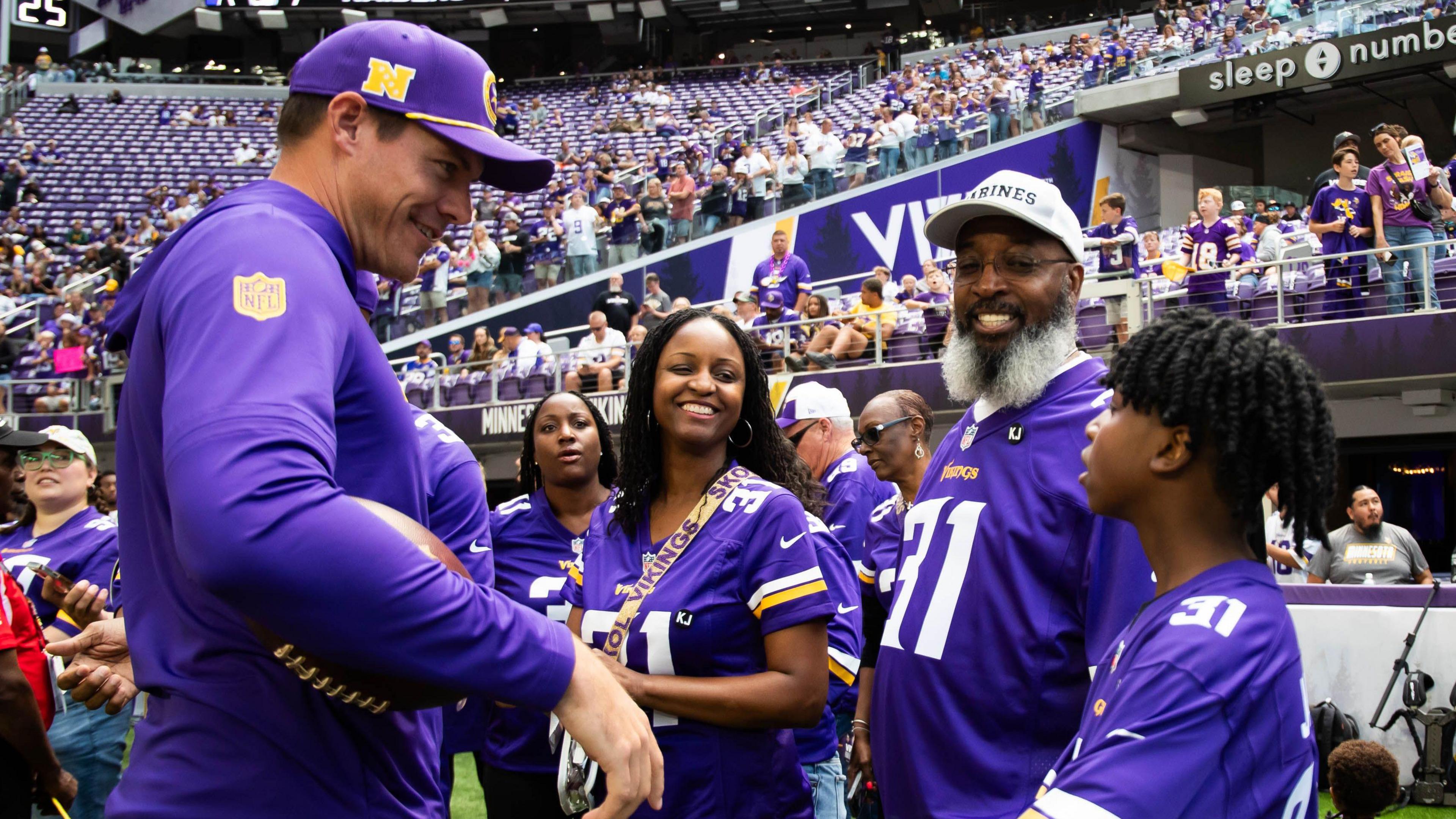 Minnesota Vikings head coach Kevin O'Connell with the family of Khyree Jackson before their pre-season game against the Las Vegas Raiders 