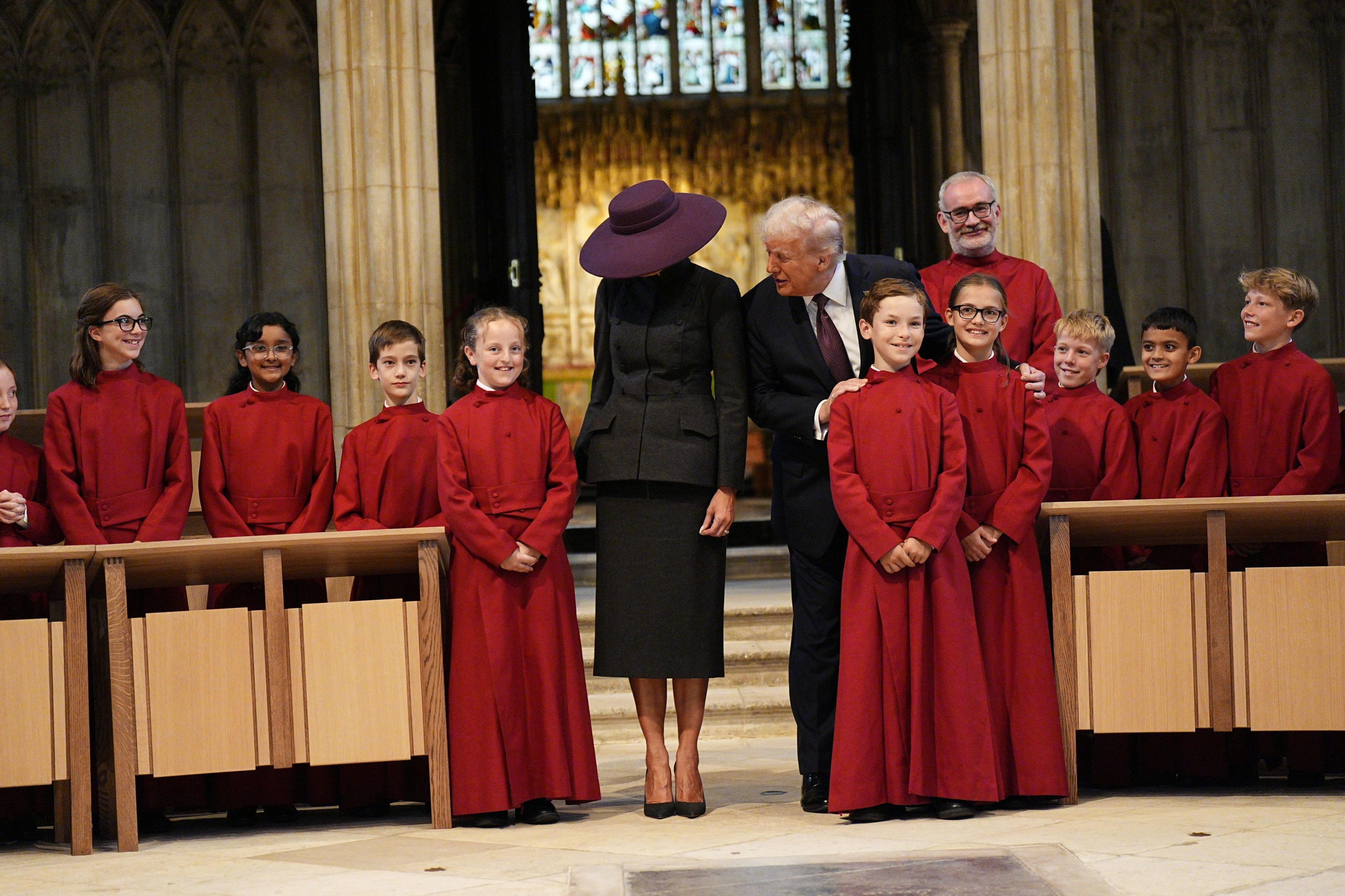 U.S. President Donald Trump and first lady Melania Trump greet a childrens choir as they receive a tour of St. George’s Chapel at Windsor Castle, Windsor,