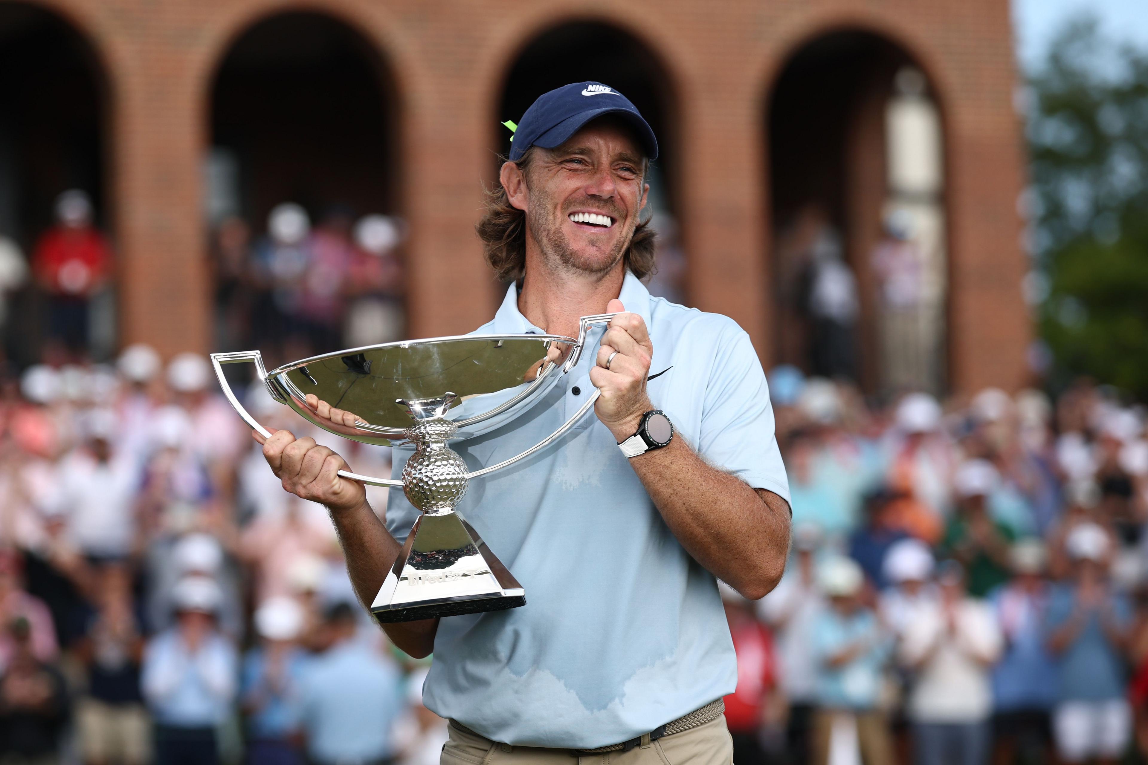 Tommy Fleetwood with the trophy after winning the Tour Championship
