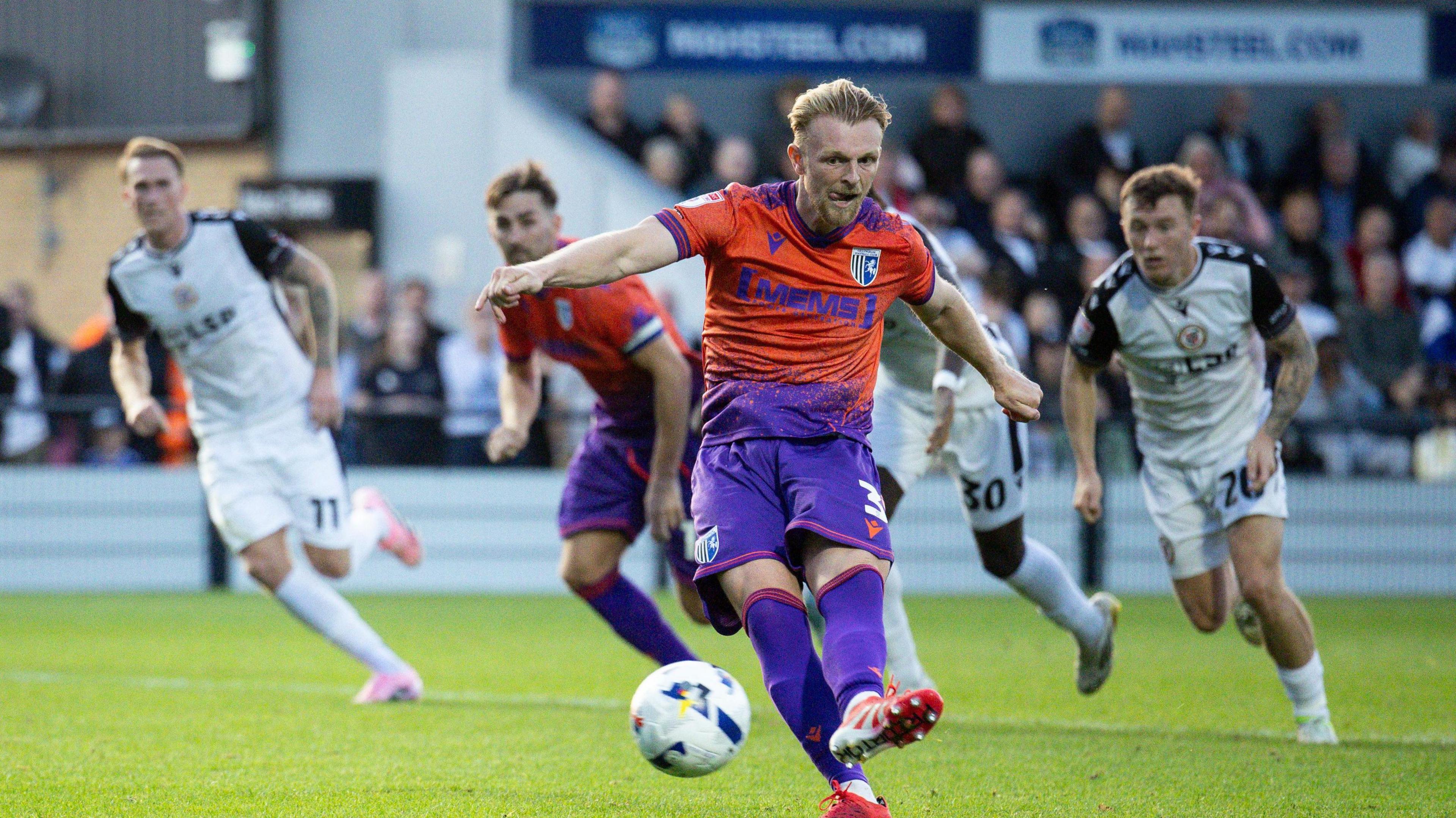 Max Clark strikes the ball from the penalty spot