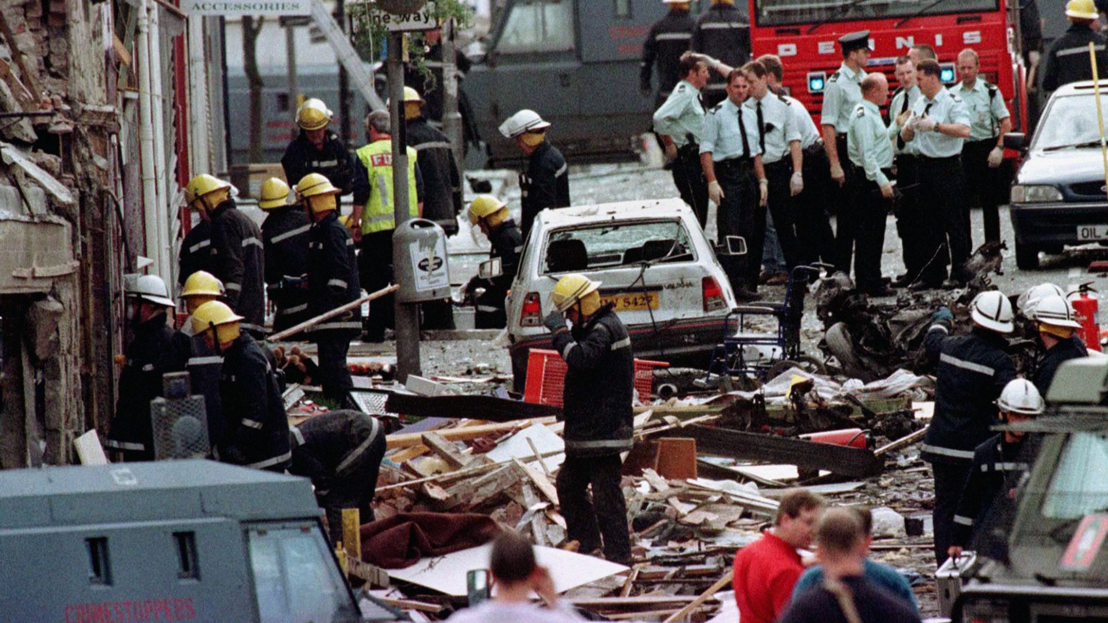 Emergency services wade through the wreckage caused by the Omagh bomb in 1998