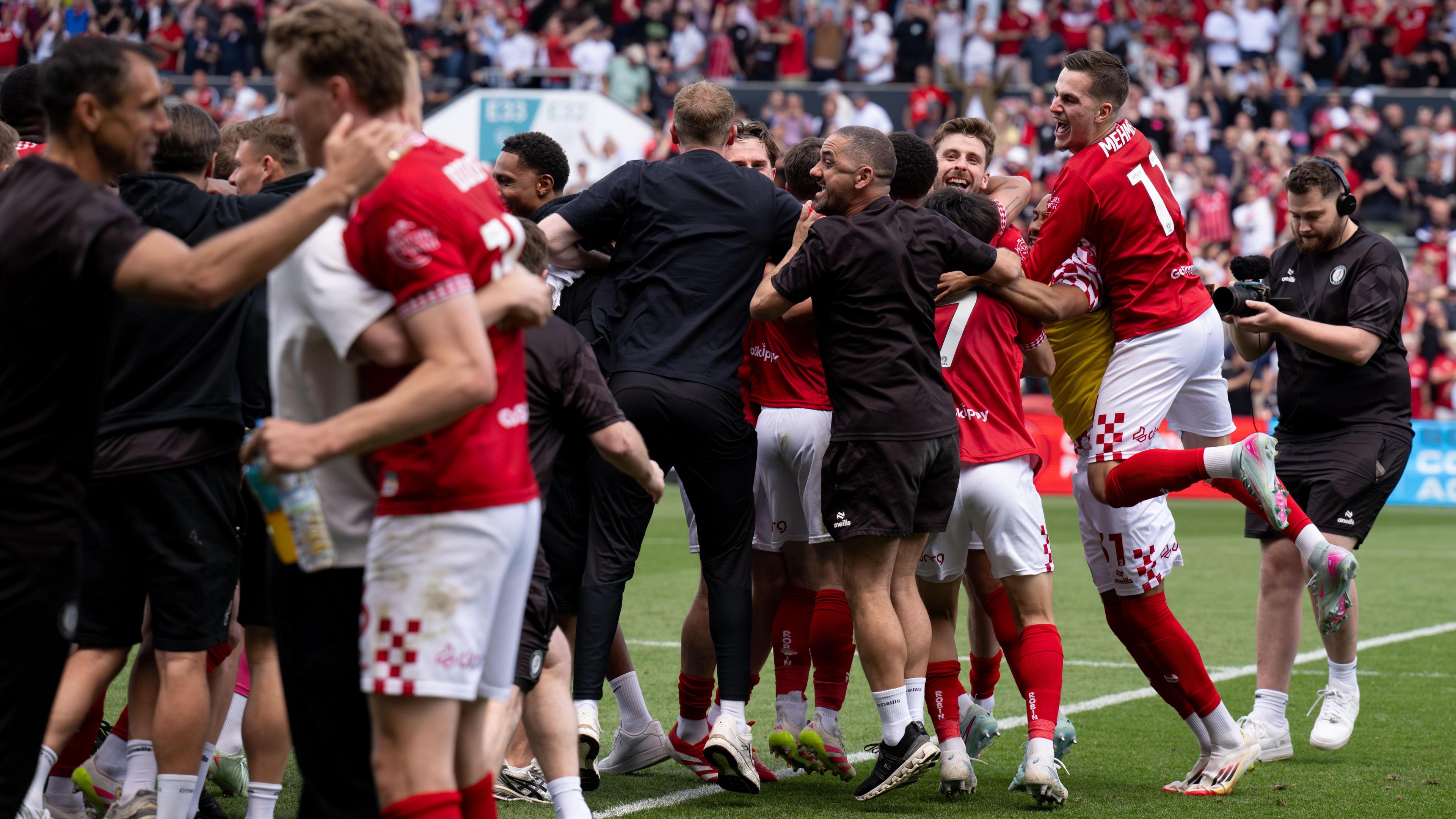 Bristol City players celebrate as their place in the play-offs is confirmed