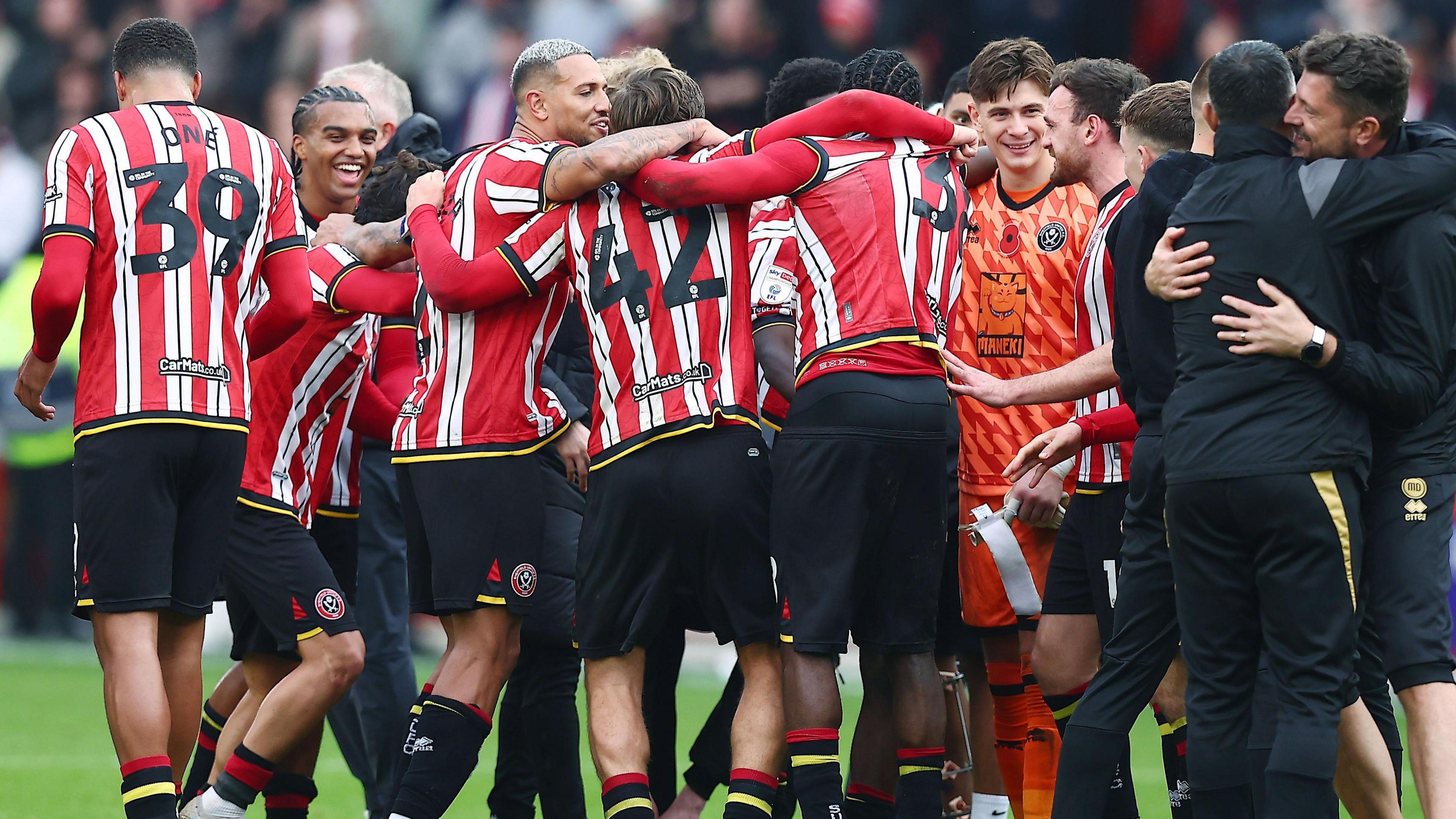 Sheffield United players celebrate at full-time after beating Sheffield Wednesday