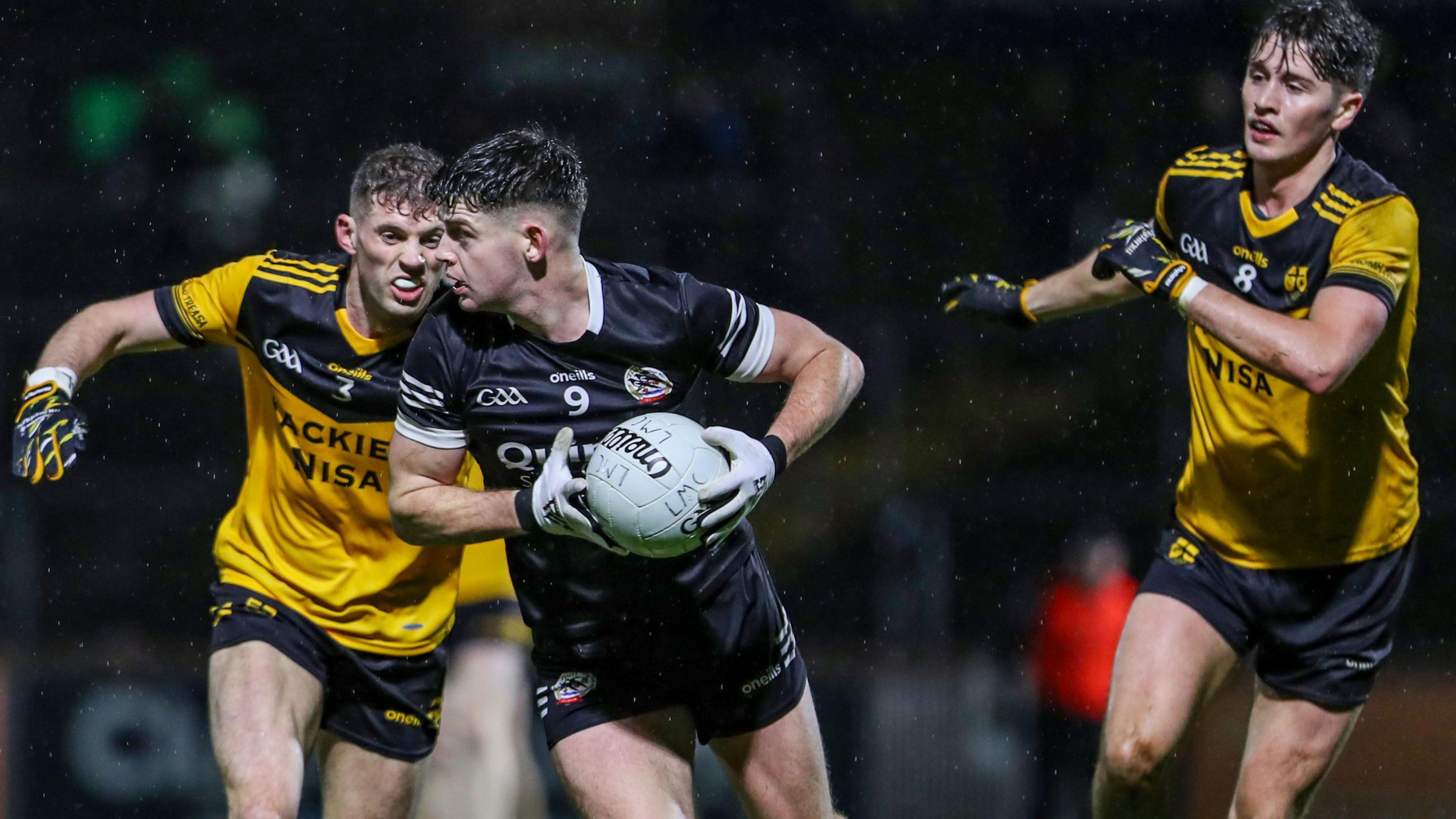 Anthony Morgan of Kilcoo gets challenged by Nathan Kelly of Loughmacory at Healy Park