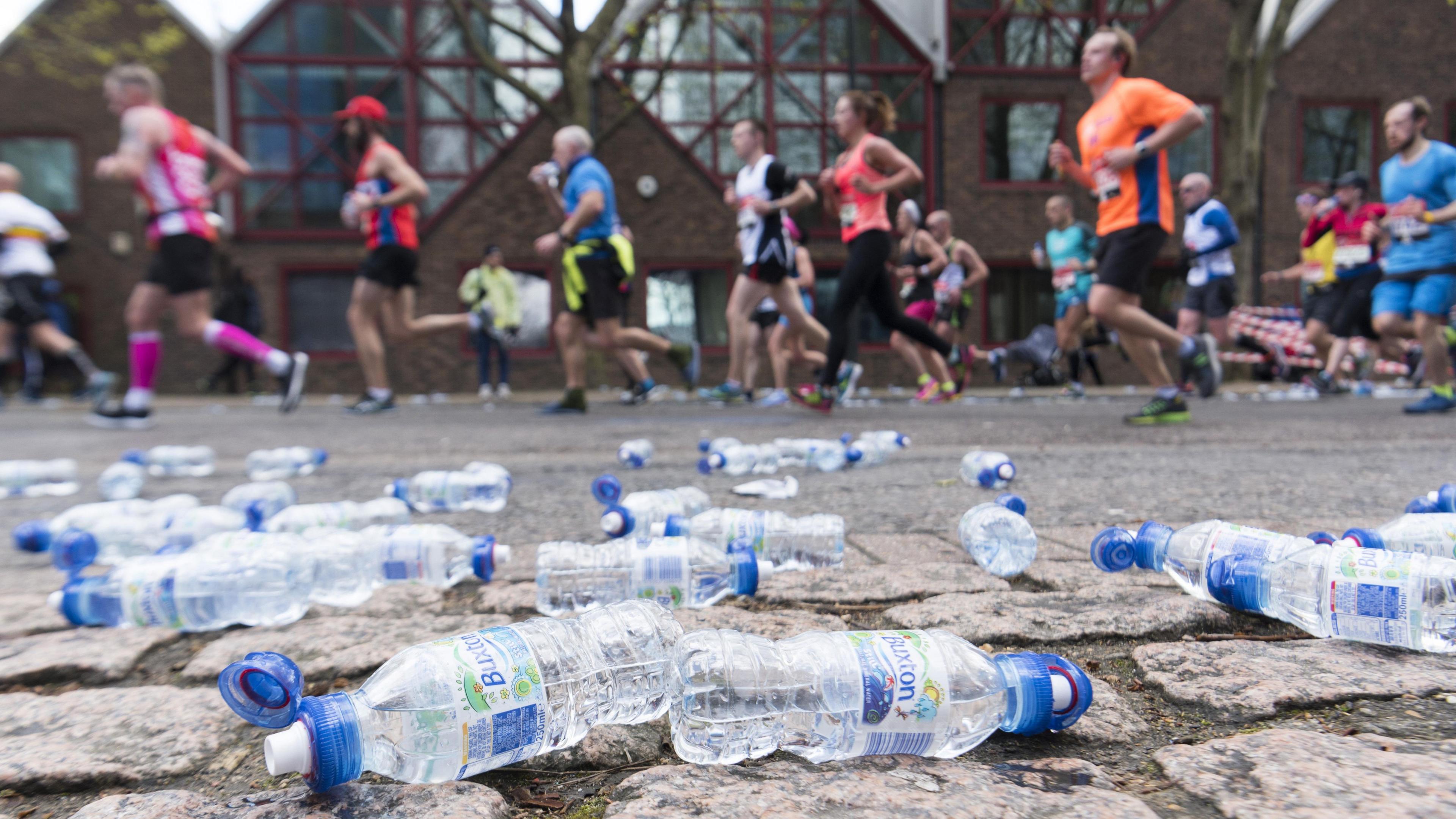 Discarded plastic bottles on the side of a marathon course 