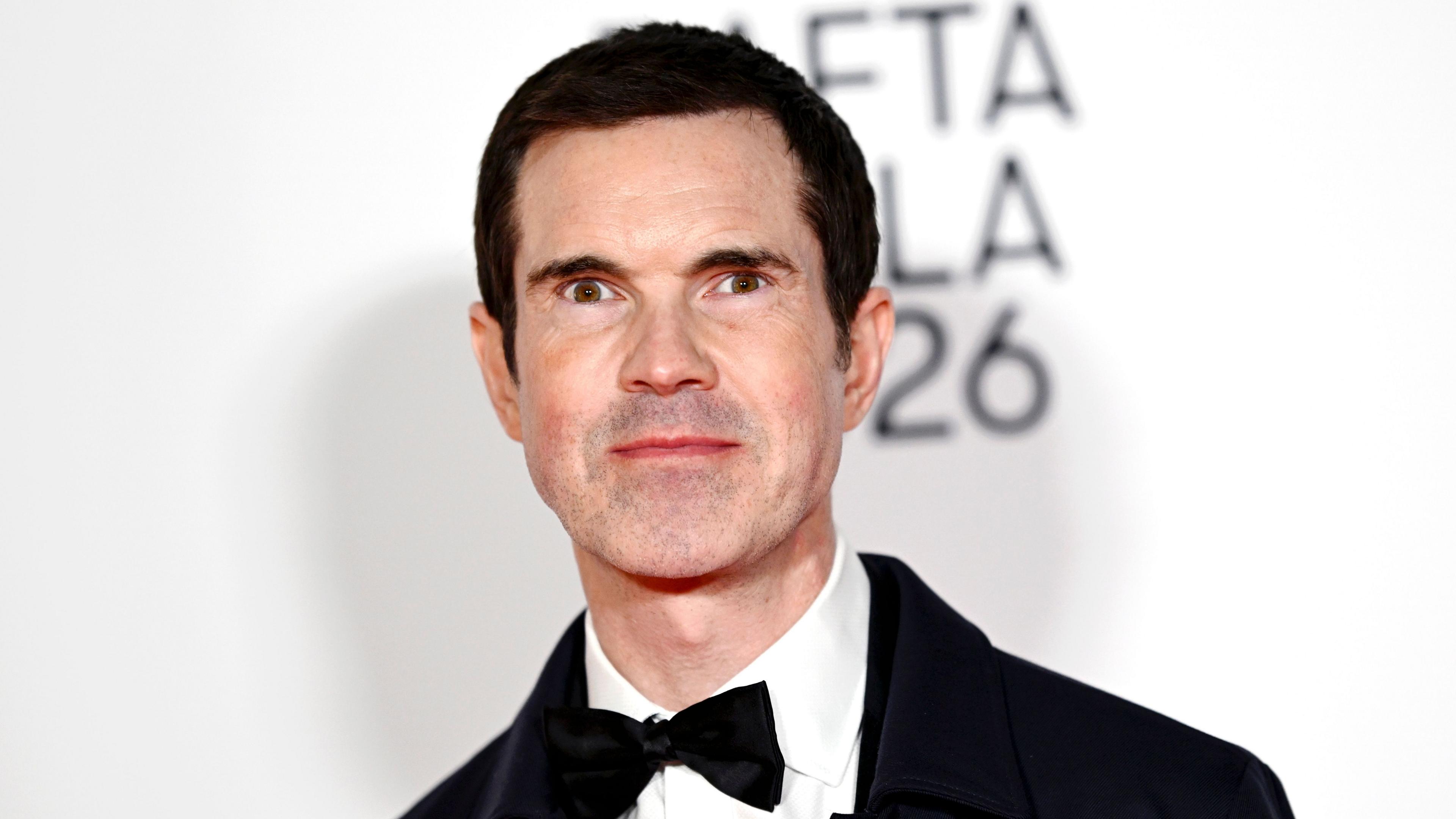 Jimmy Carr in a black bow tie and suit
