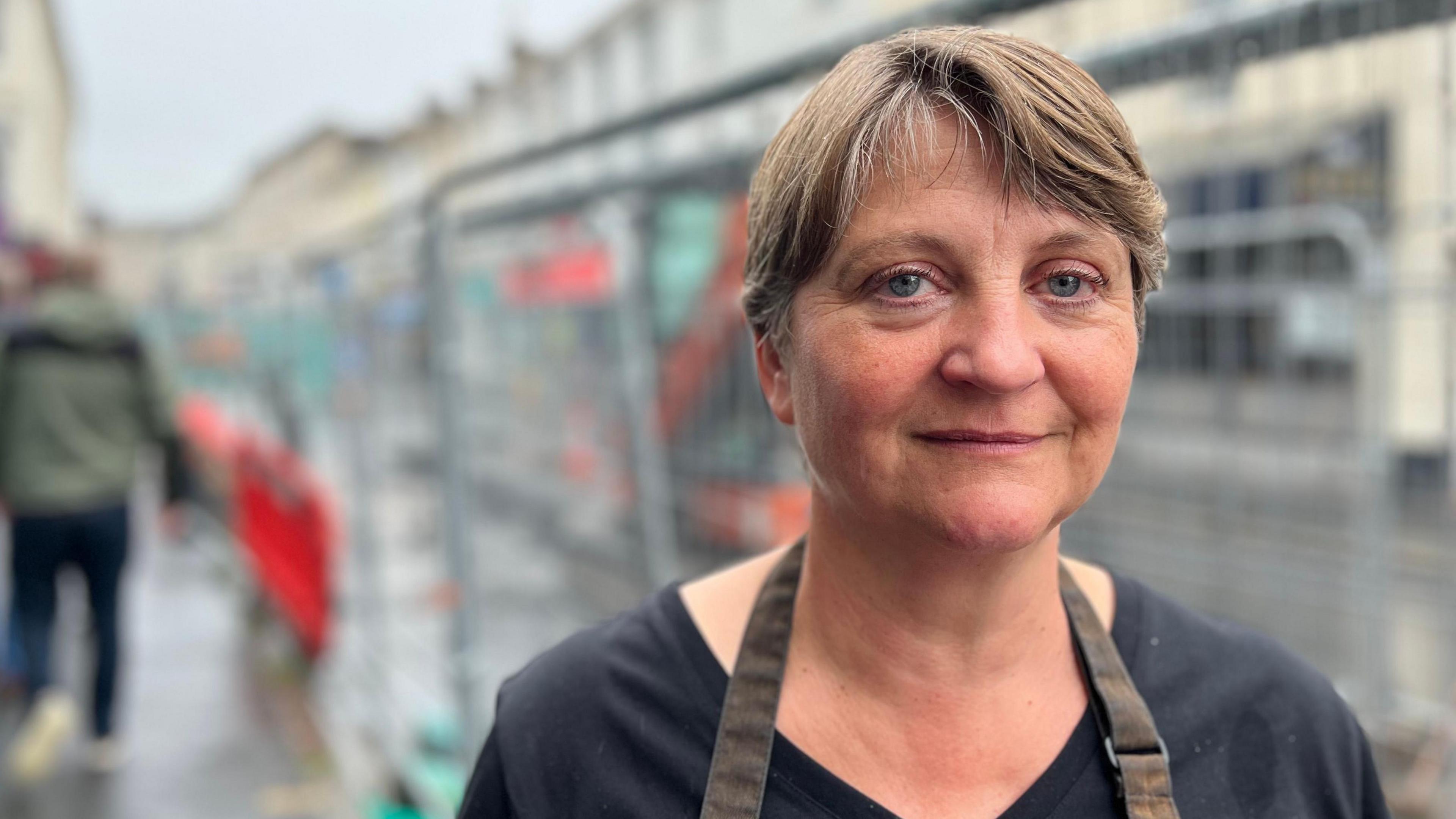 Claire Quelvennec standing in front of the ongoing works in Queen Street