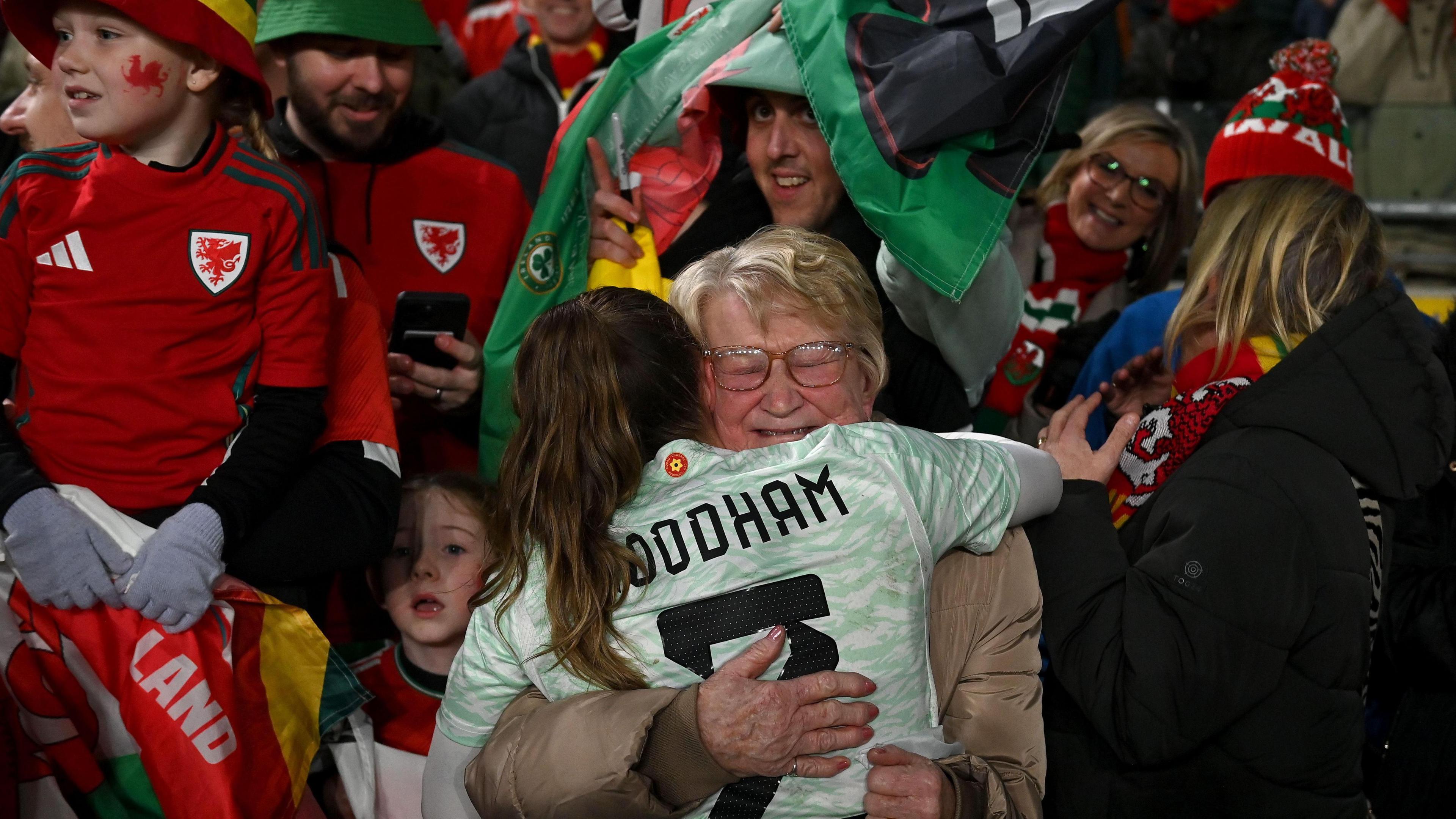 Lily Woodham of Wales celebrates with family following the UEFA Women's EURO 2025 Play-Off Round Two Second Leg match between Republic of Ireland and Wales at Aviva Stadium on December 03 2024.