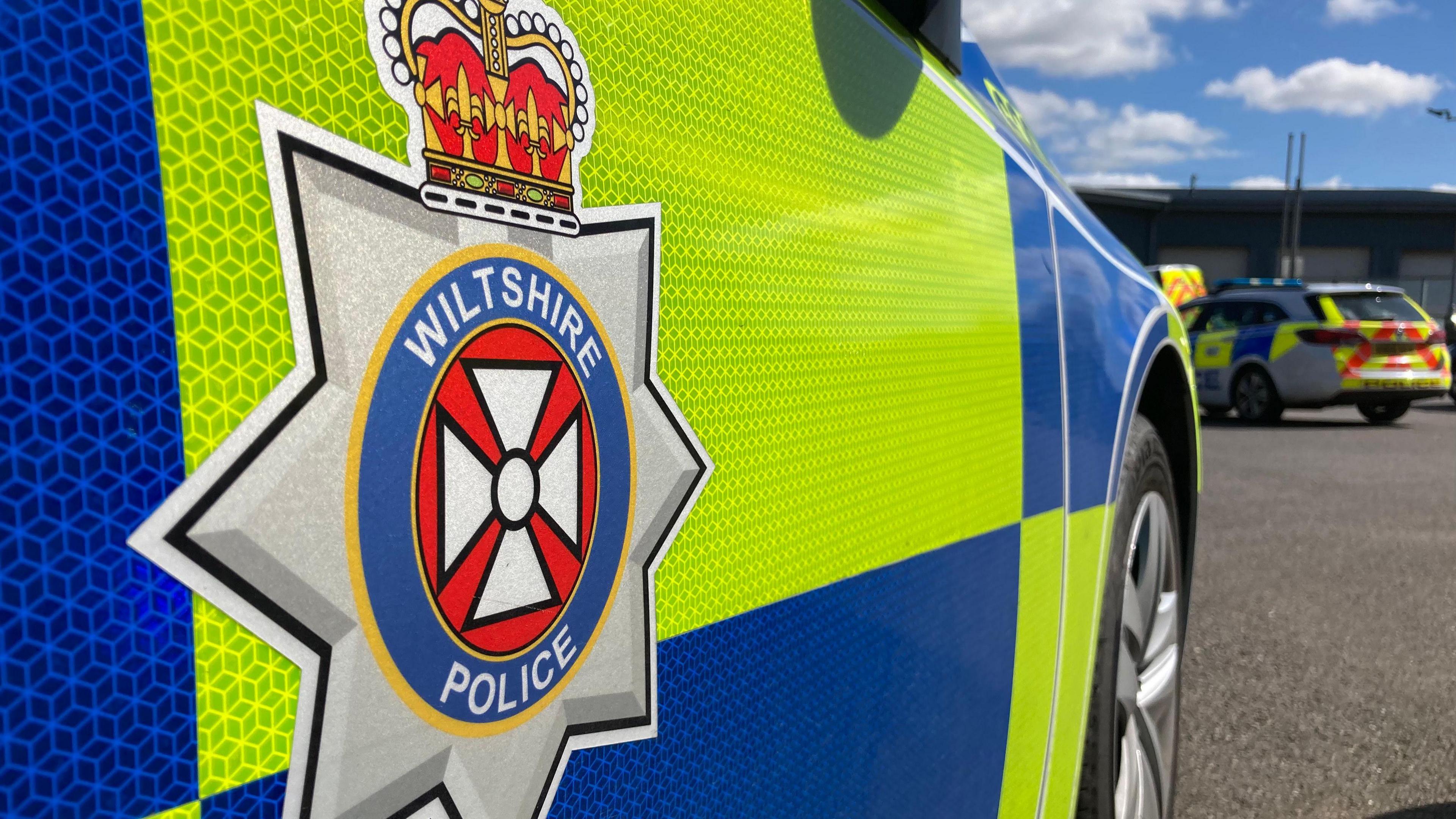 A generic close-up shot of the side of Wiltshire Police car showing the logo