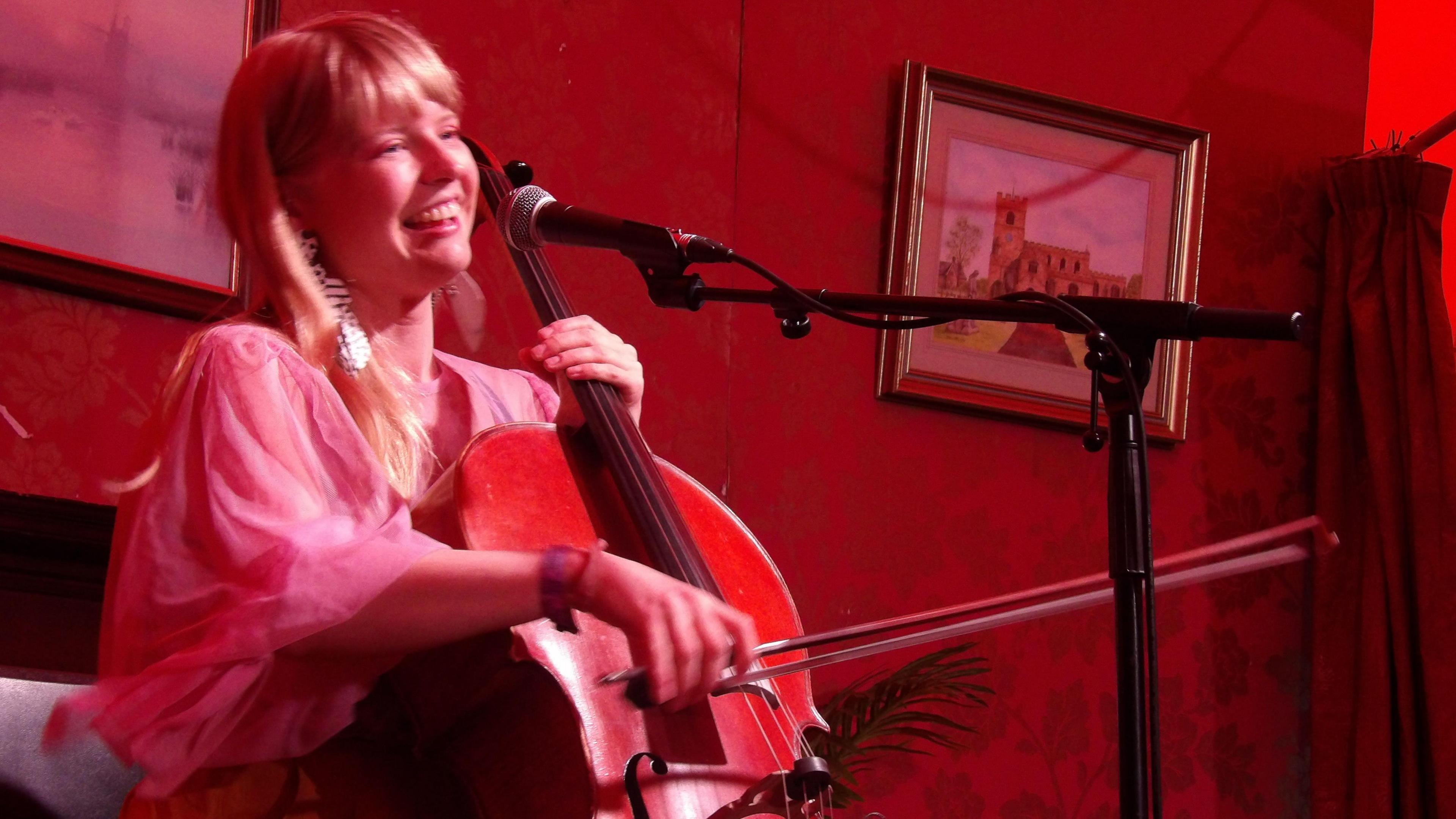 Monique Clare with cello a the Cambridge Folk Festival