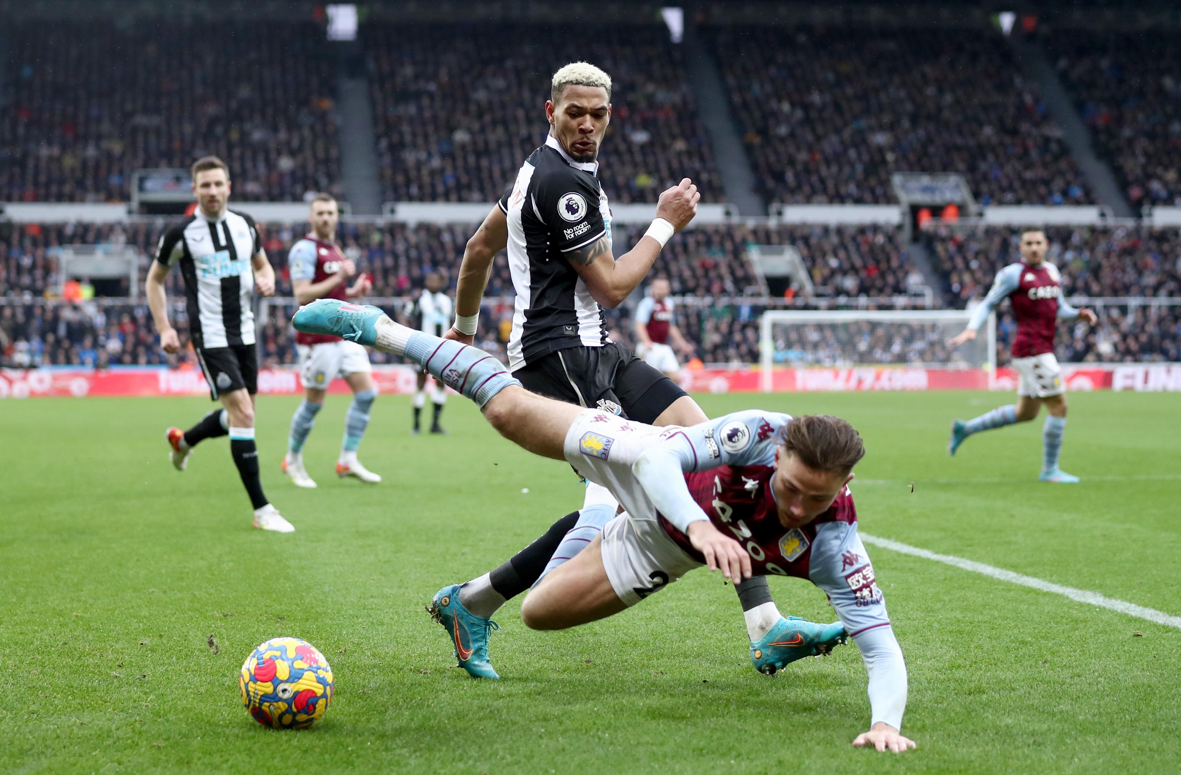 Joelinton challenges Matty Cash for the ball