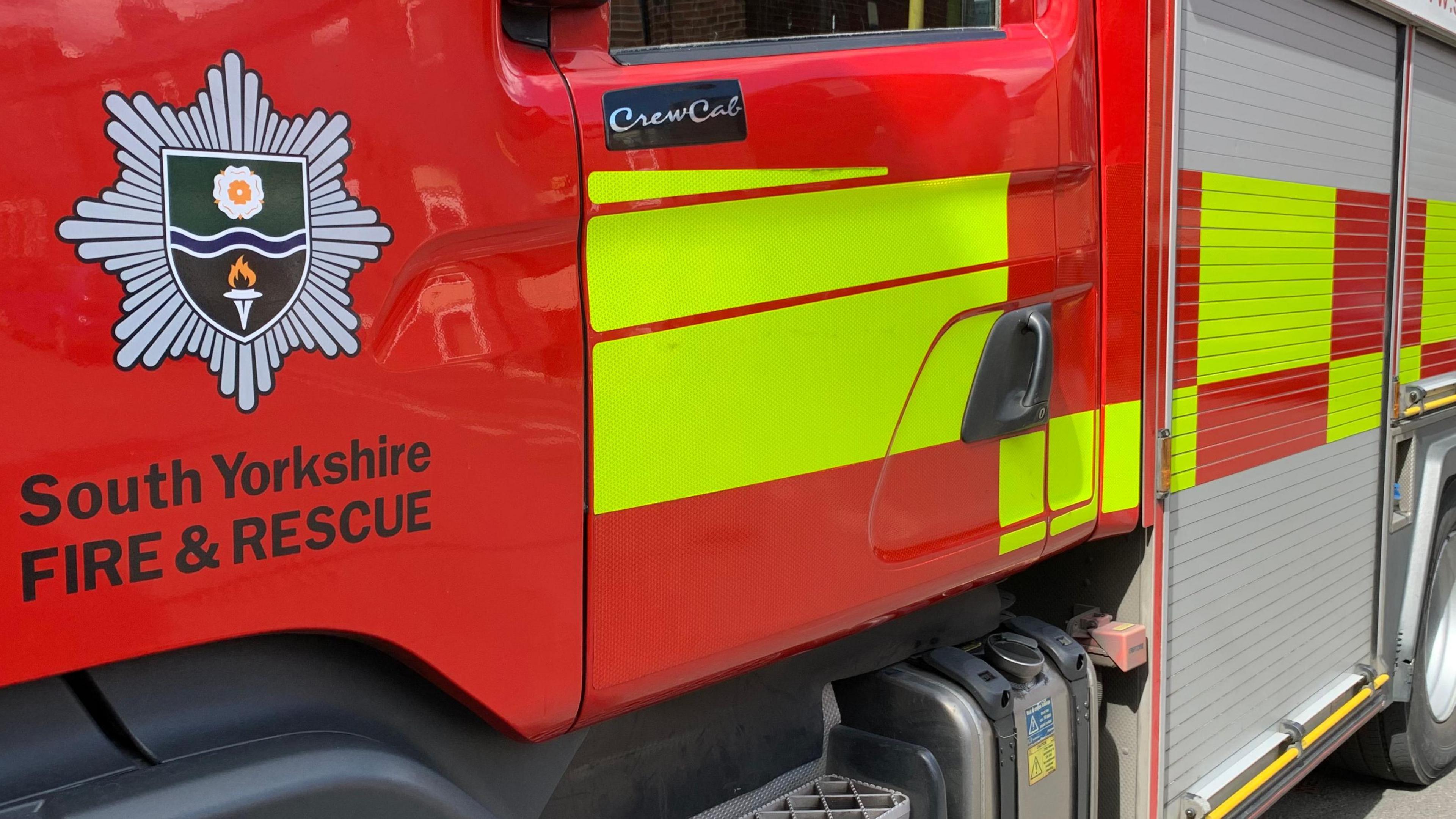 A South Yorkshire Fire and Rescue logo on the side of a fire engine