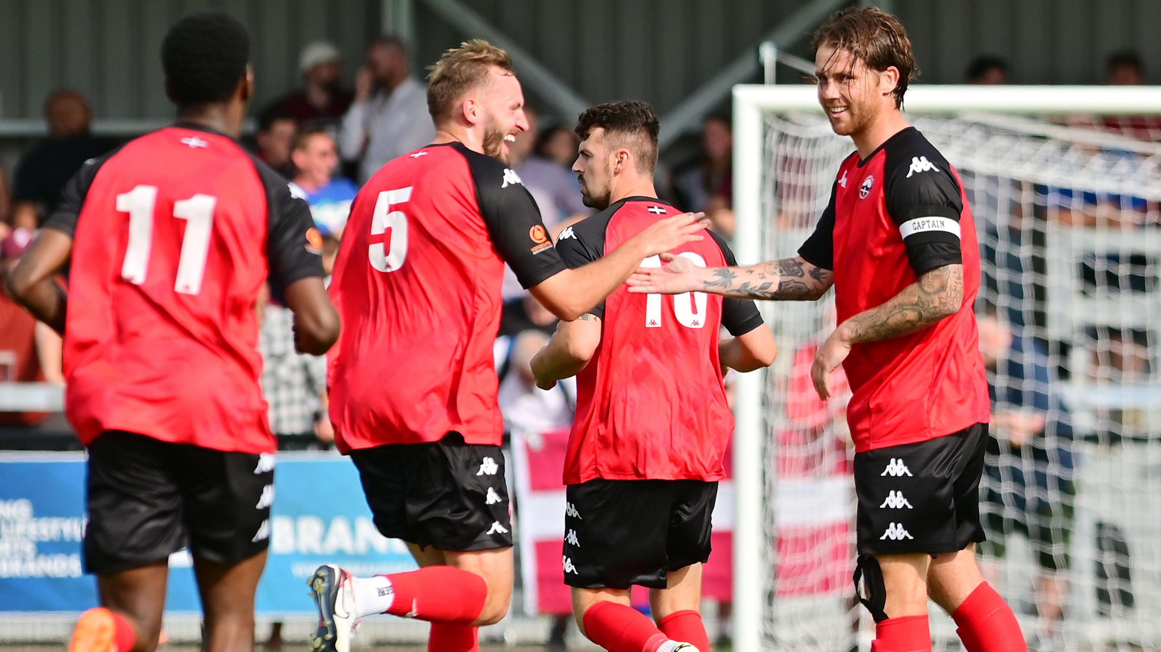 Truro City players celebrate a goal