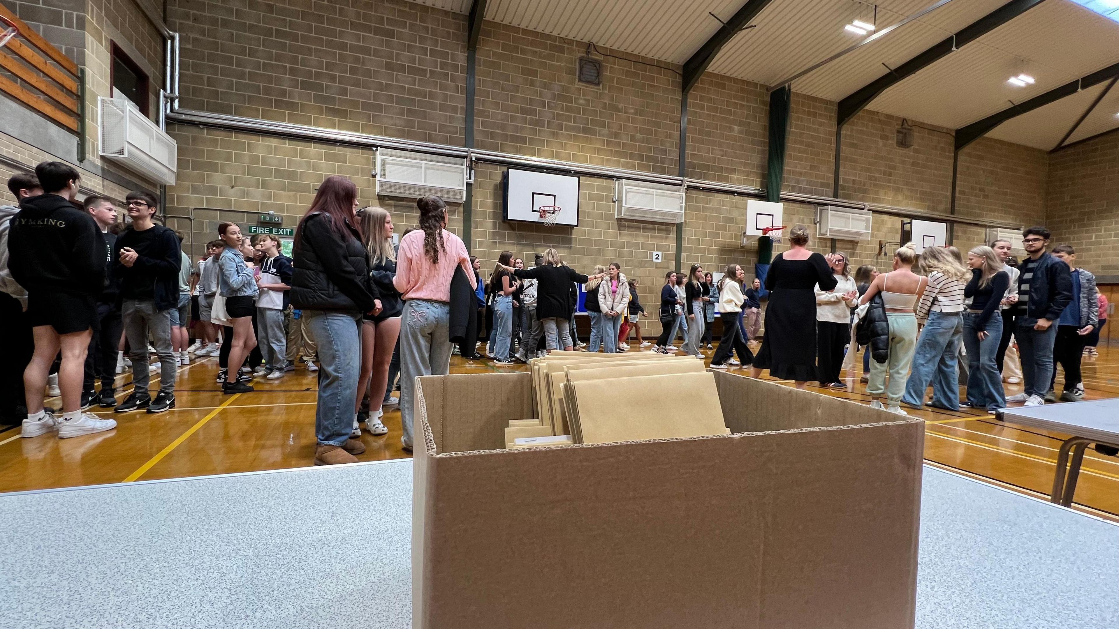 GCSE results in a box with students in the background