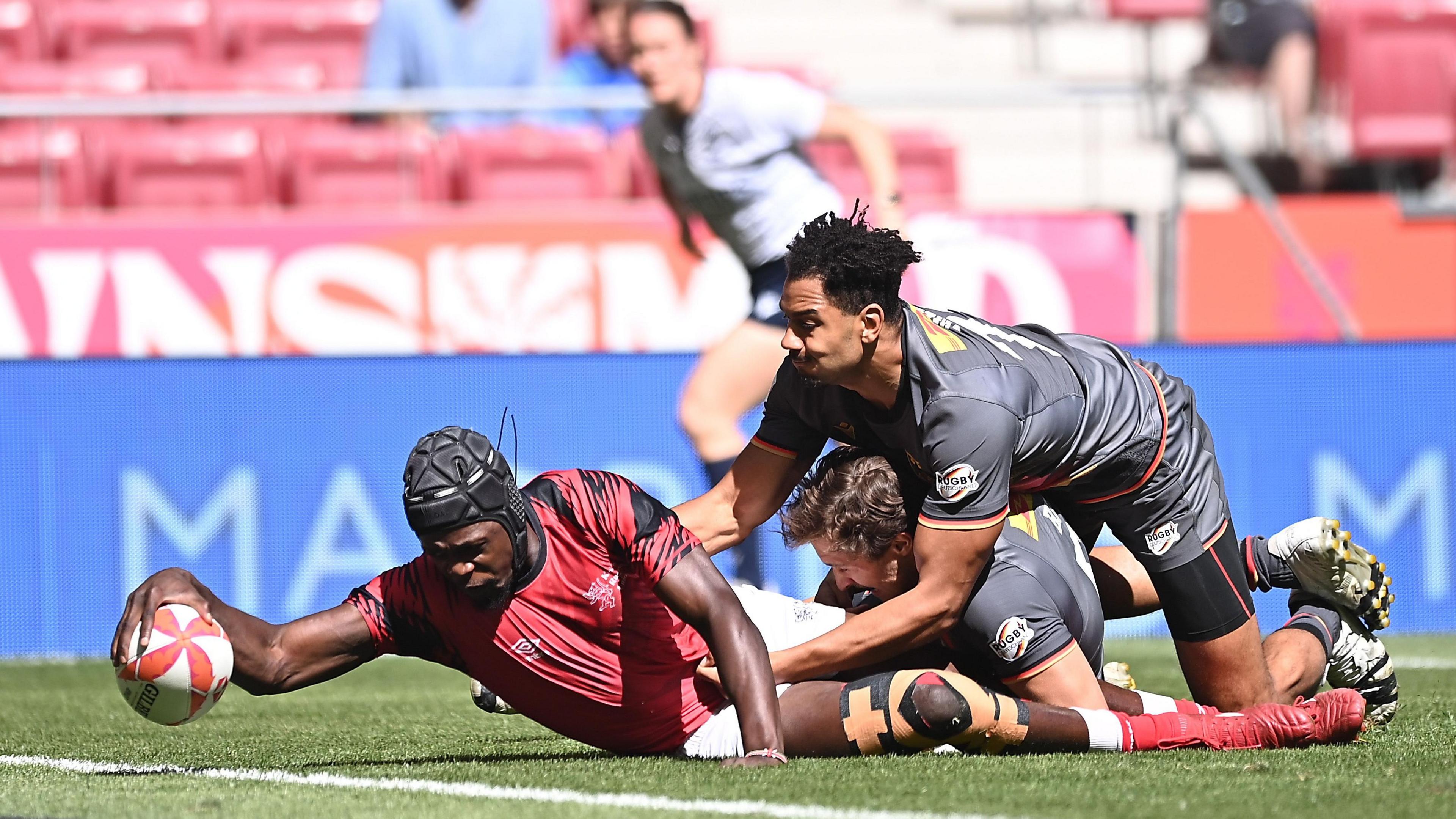 Vincent Onyala of Kenya scores a try during a rugby sevens match against Germany