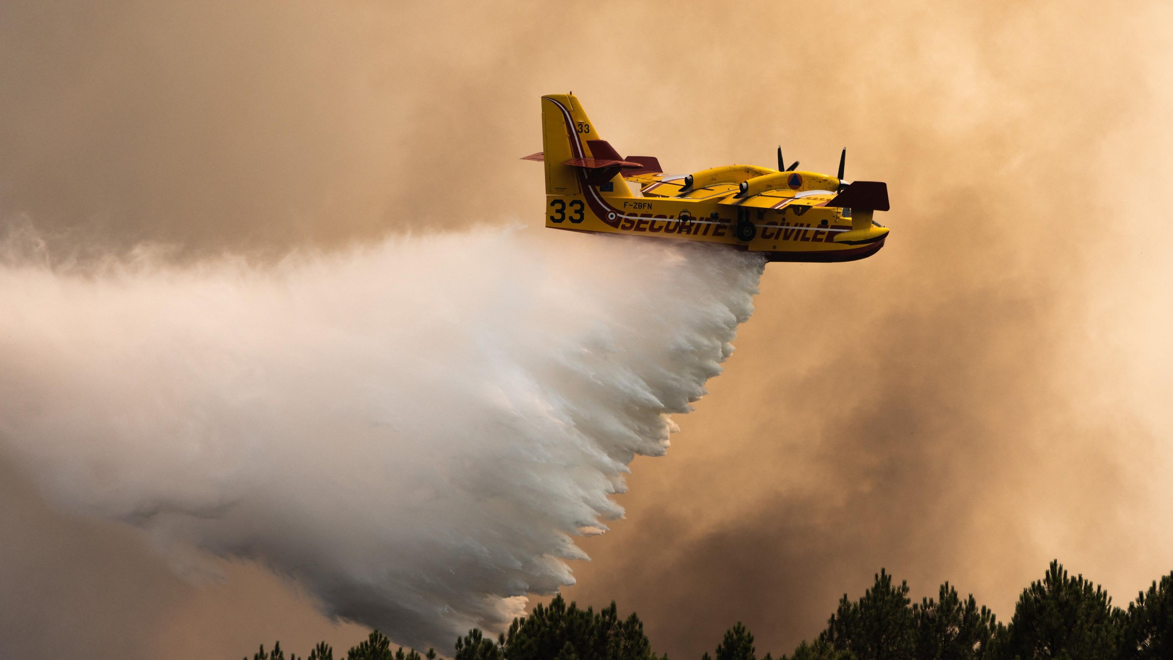A Canadair firefighting plane drops water on a fire in the Gironde region of France in July.