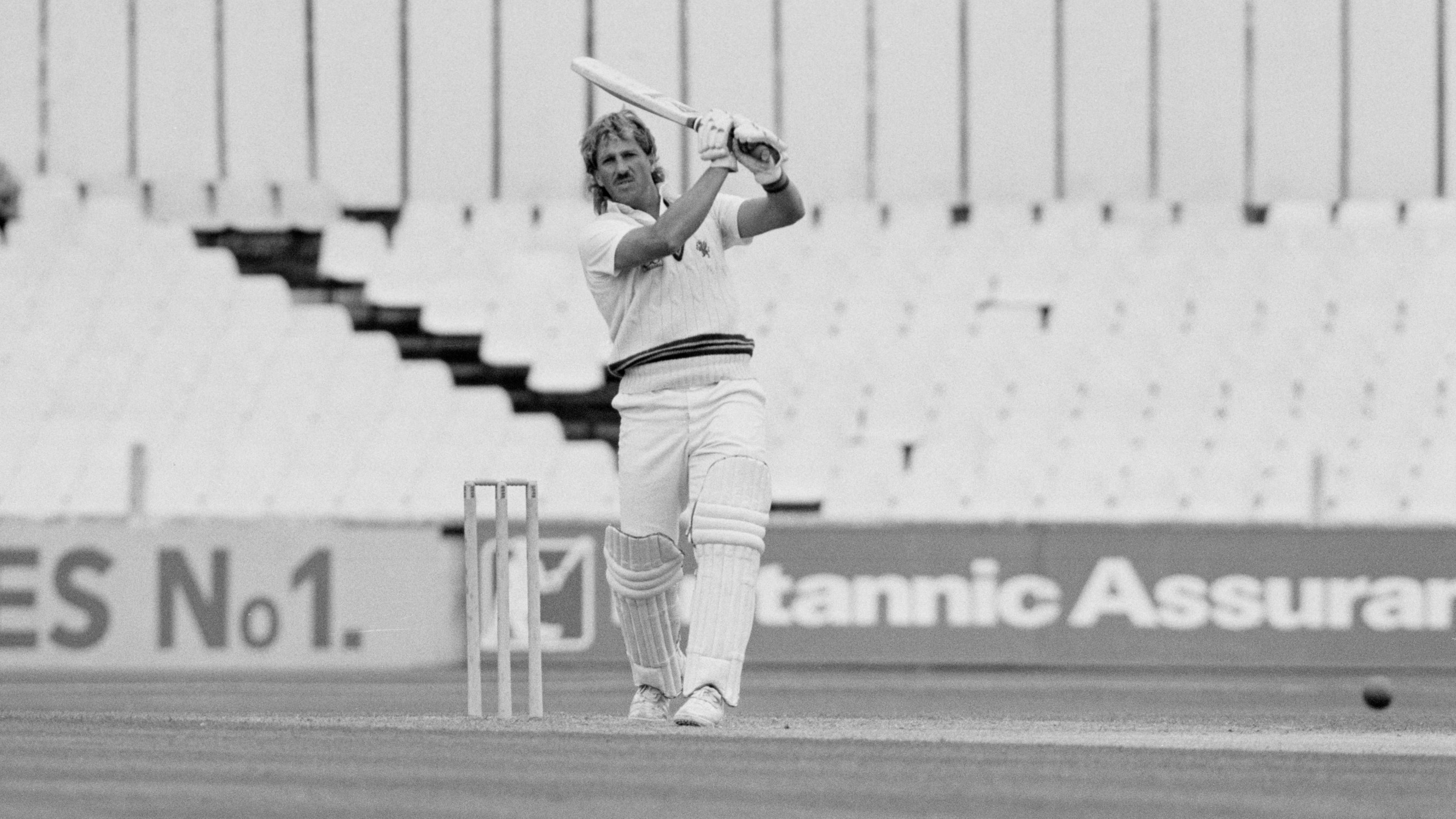 Ian Botham holds the bat above his head after hitting a shot while playing for Somerset in 1981