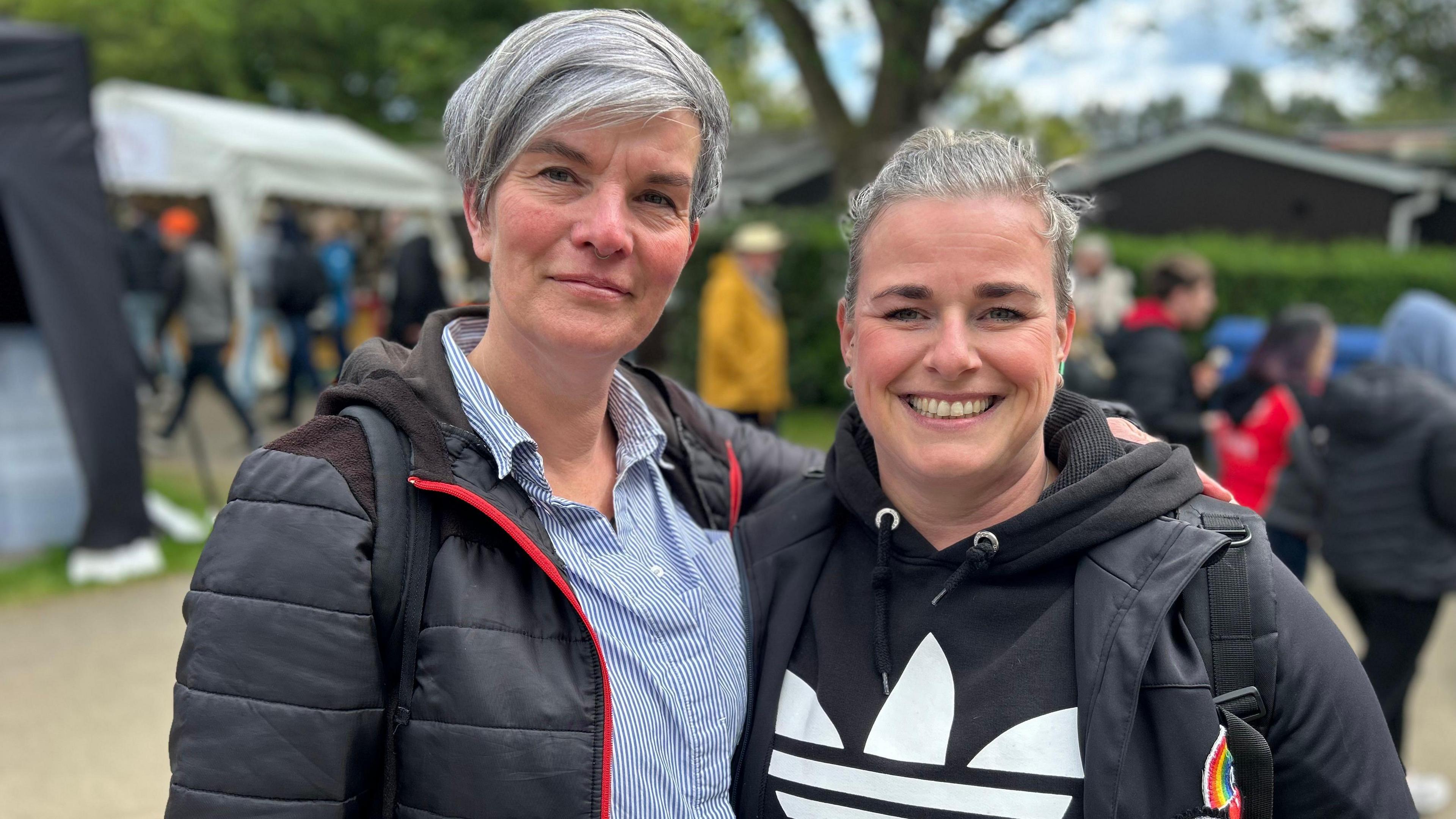 Two women both wearing black jackets at the Isle of Man TT