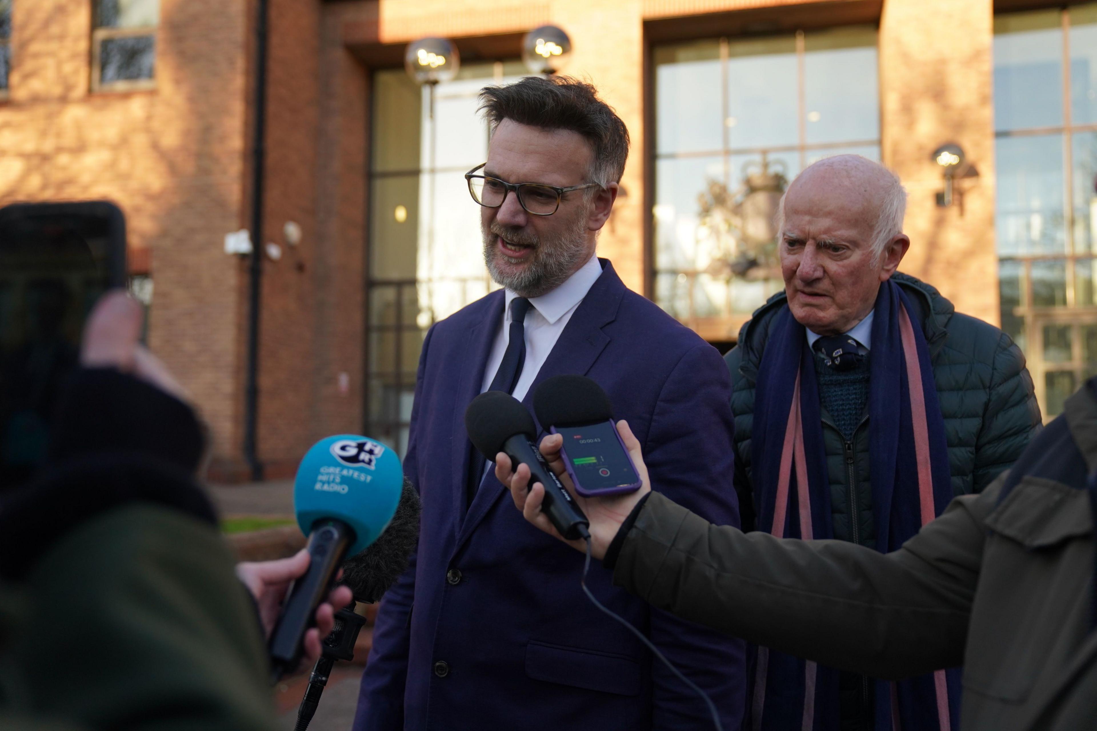 Charles Hanson talking to journalists outside court.