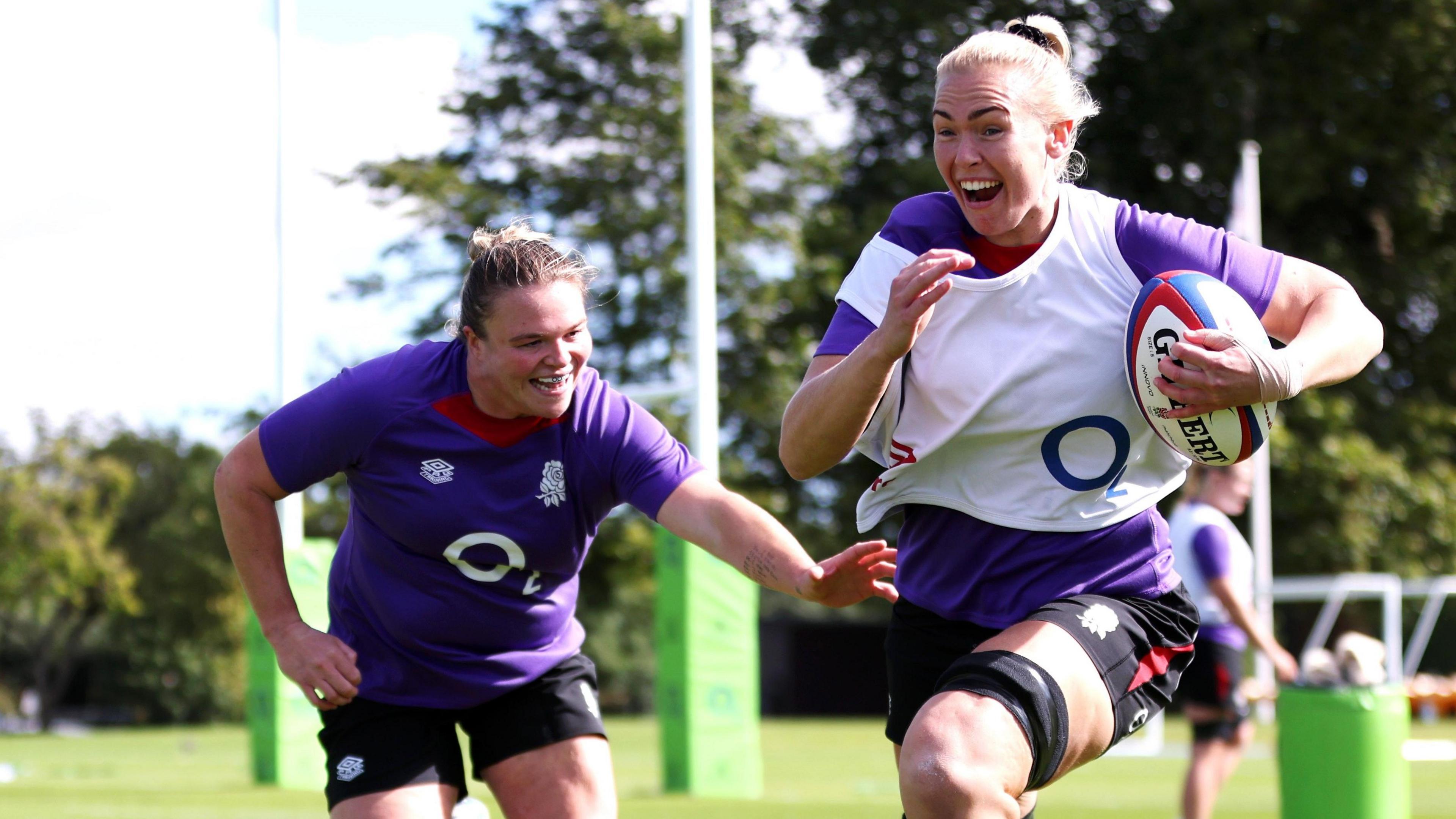 Rosie Galligan carries the ball in training with Sarah Bern 