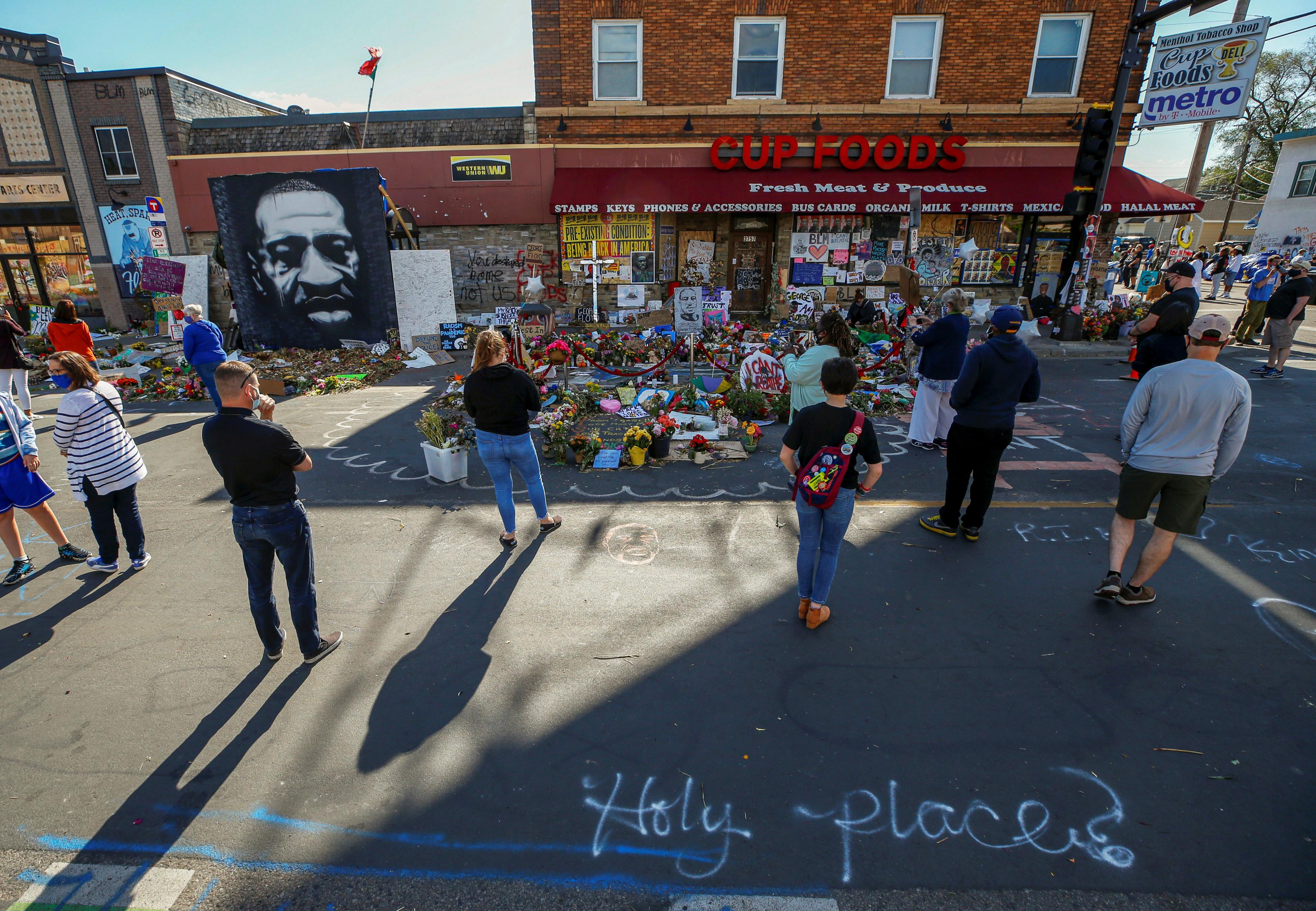 Visitors look at a memorial at the site of the arrest of George Floyd, who died while in police custody, in Minneapolis, Minnesota, US