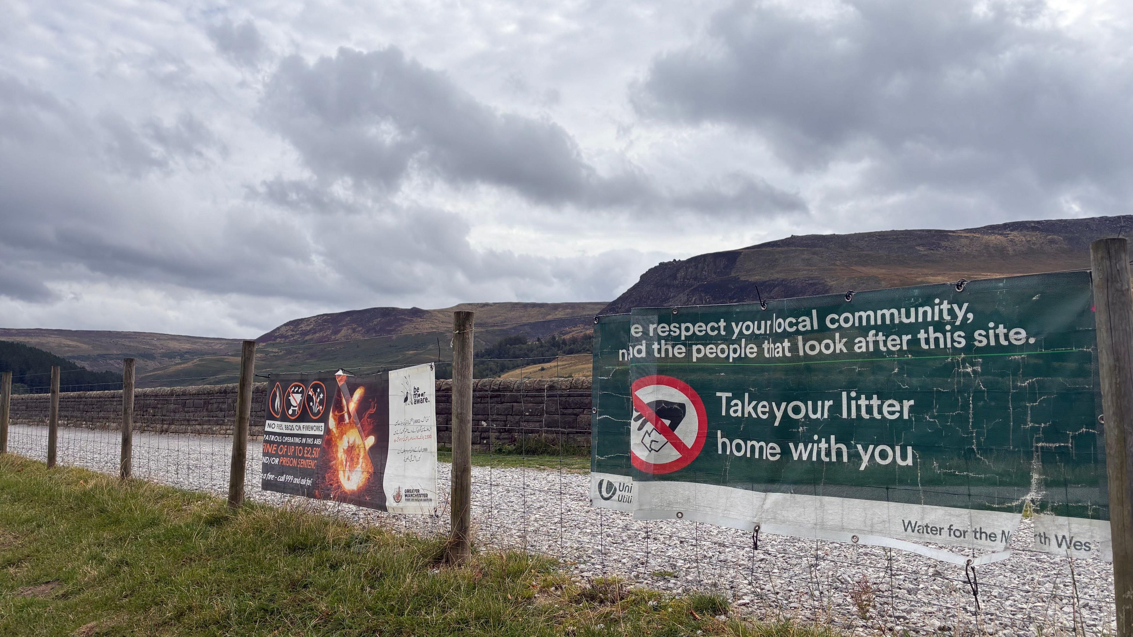 Signs around the pathways warning people to take litter home with them
