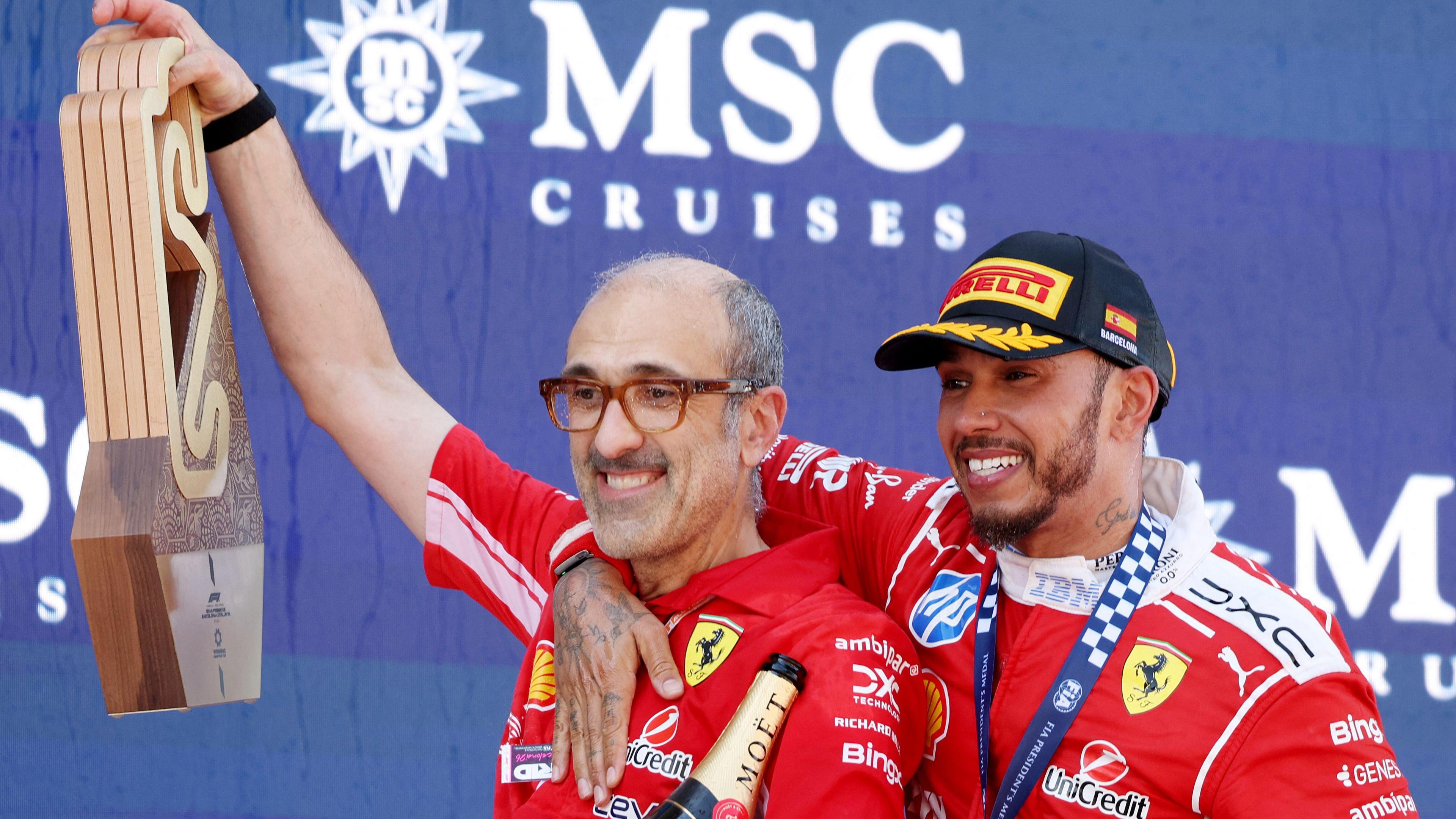 Ferrari's Lewis Hamilton with his right arm around the shoulder of his race engineer Carlo Santi following his victory in the Barcelona-Catalunya Grand Prix