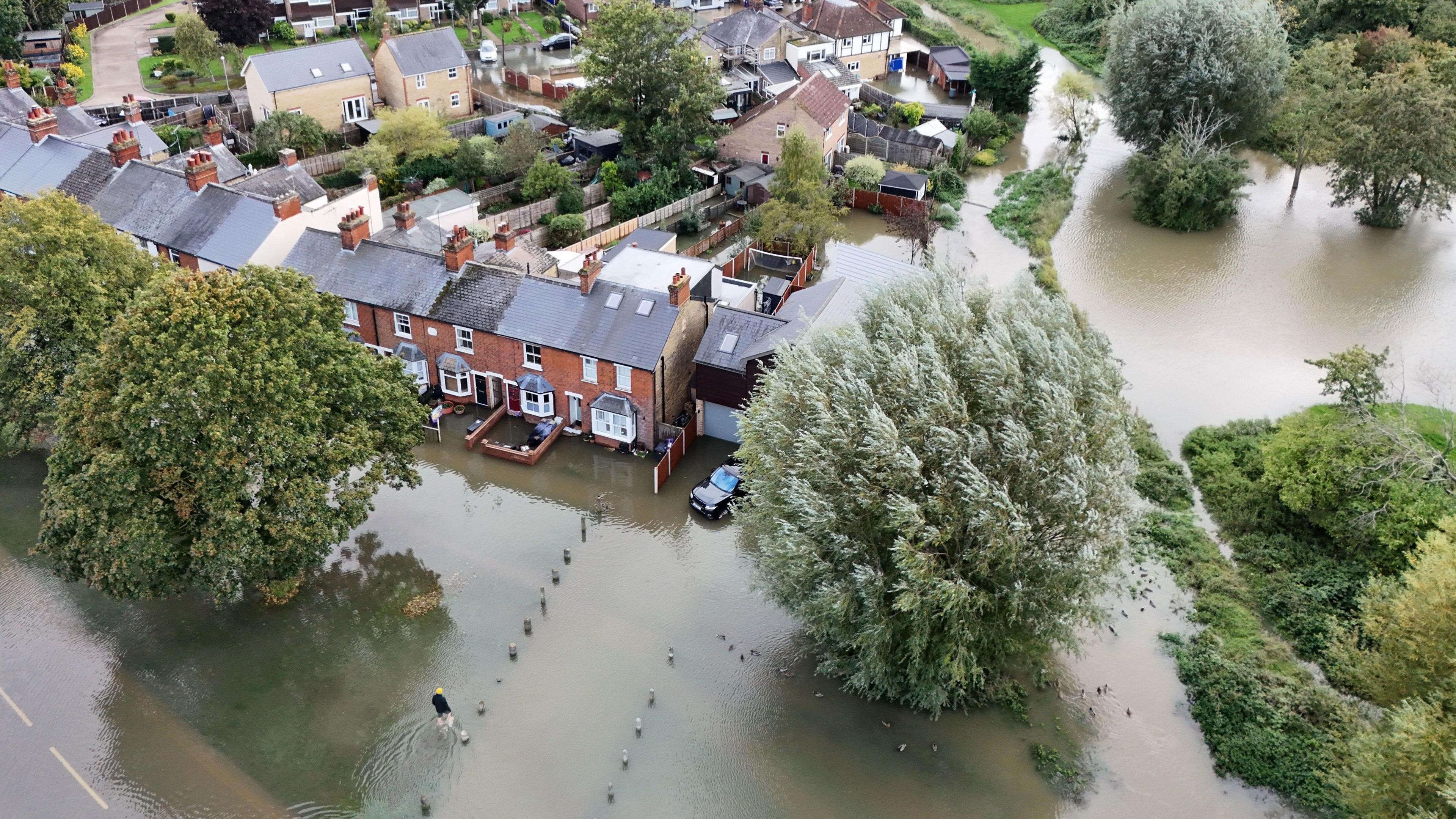 An aerial picture shows terraced housing surrounded by floodwater.