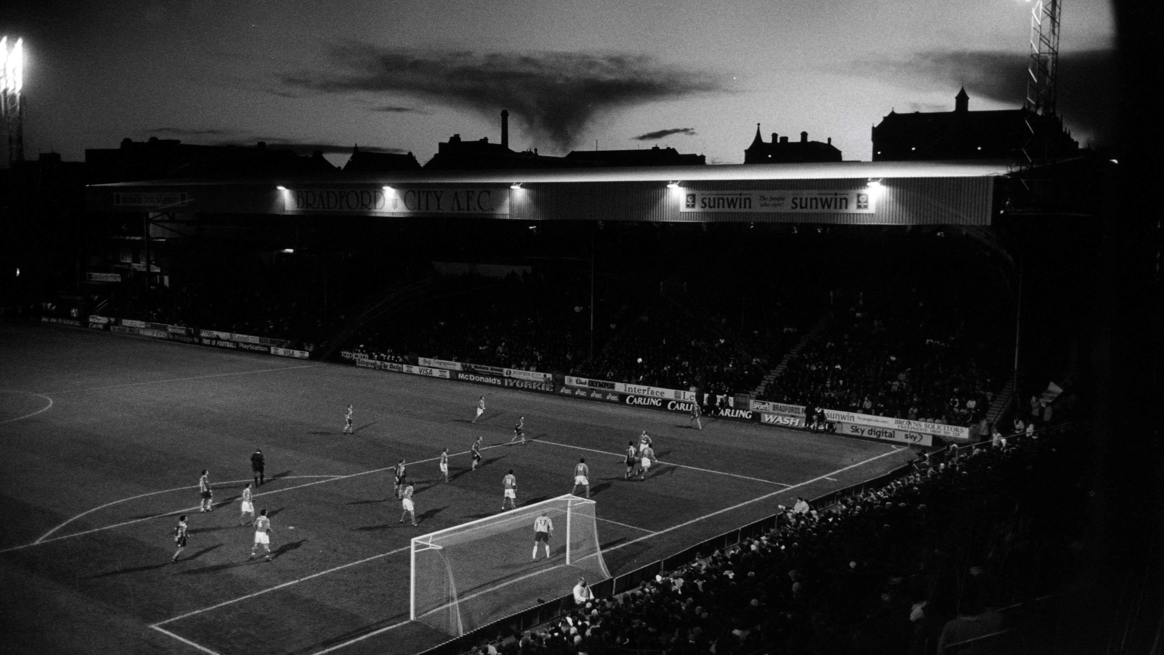 A black-and-white shot of Bradford City's home ground Valley Parade taken from a distance back in the stands.