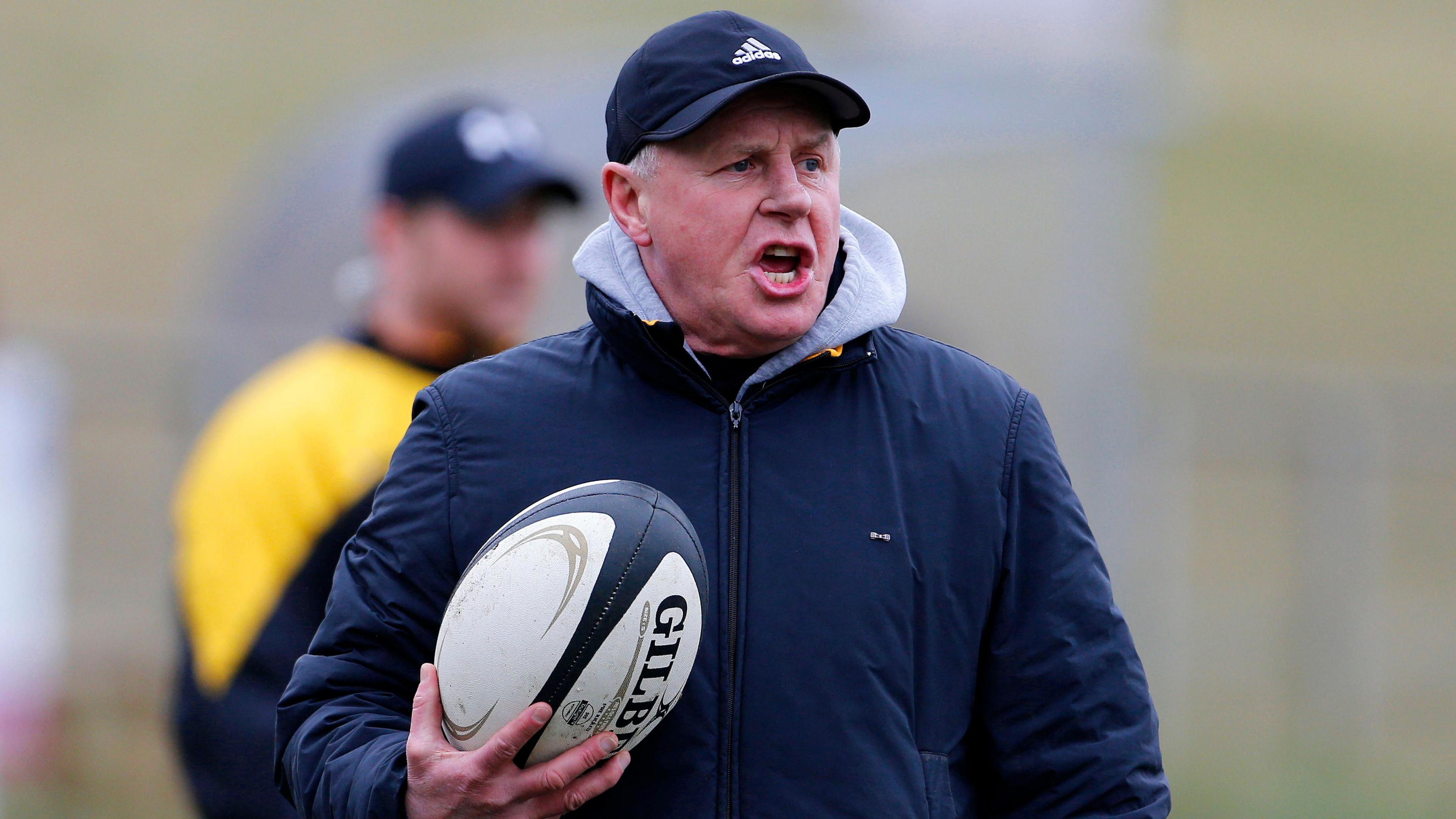 Ampthill Rugby head coach Paul Turner shouting instructions with a rugby ball under his right arm