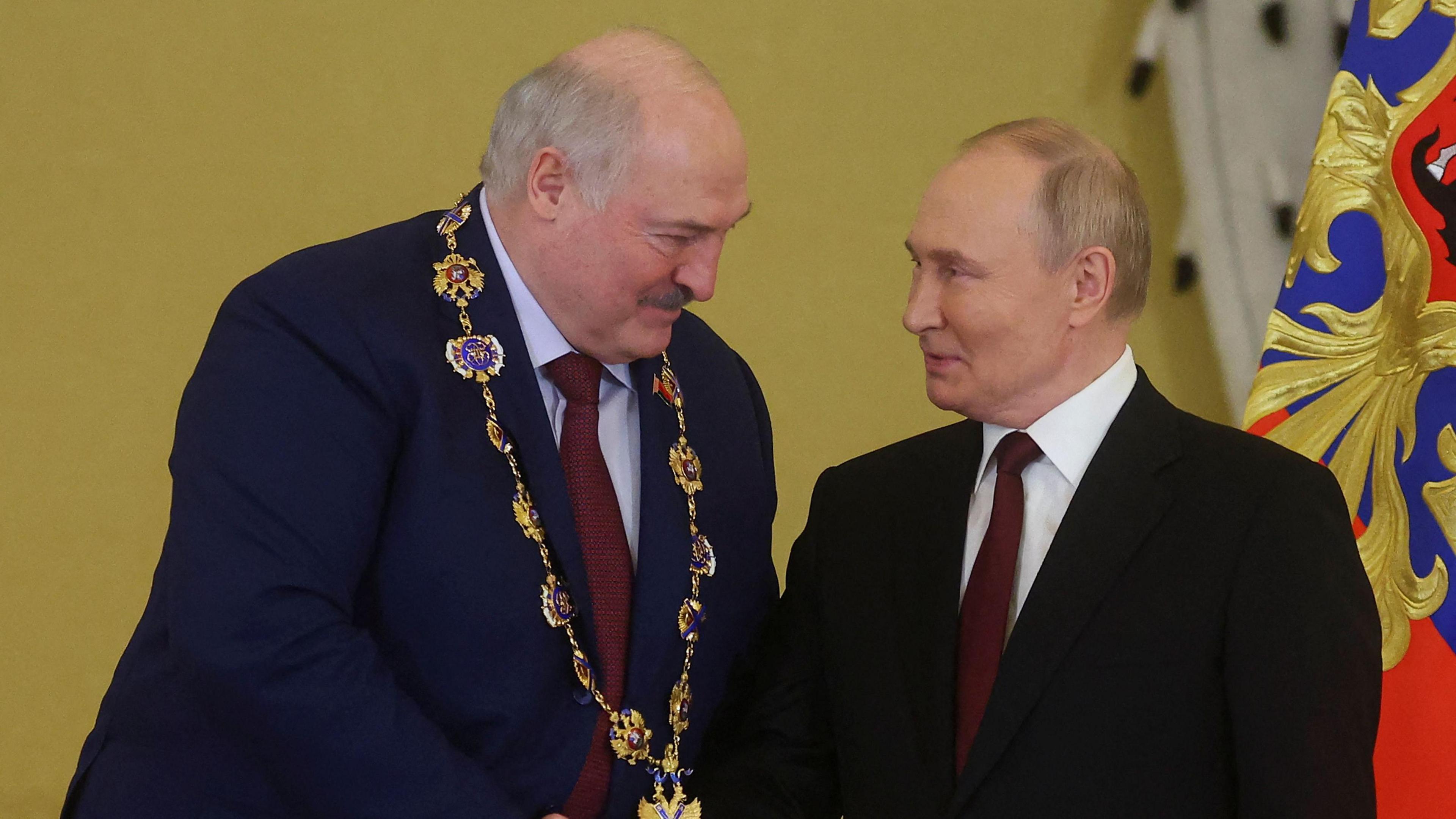 Alexander Lukashenko and Vladimir Putin shake hands 