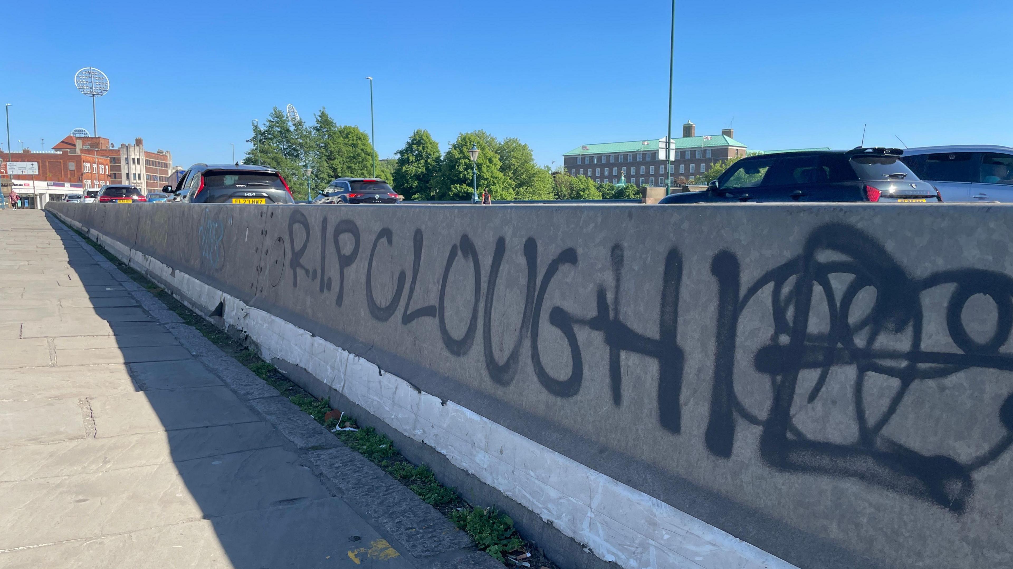 Graffiti on a barrier going across Trent Bridge