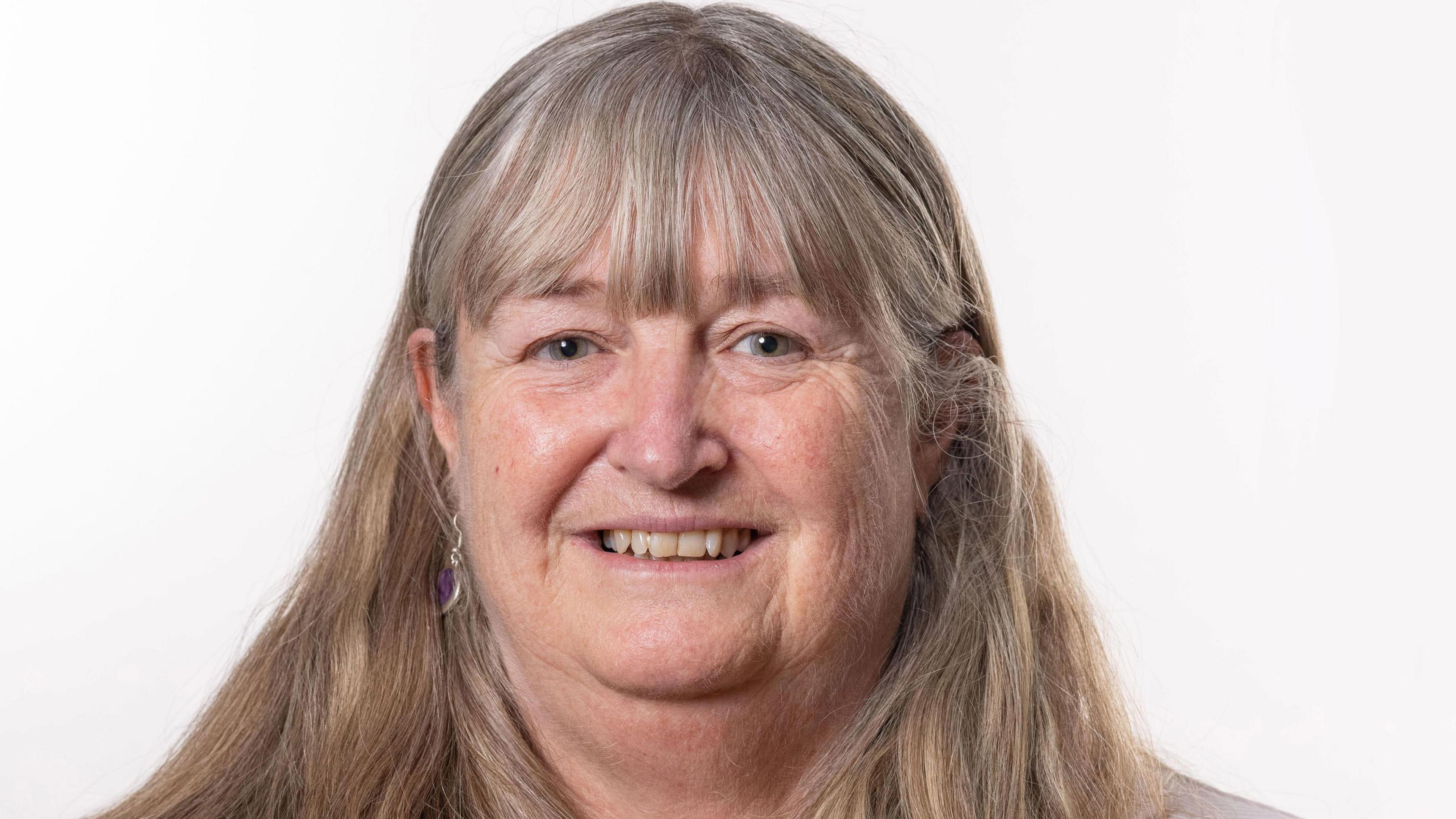 Julie James mewn llun swyddogol Llywodraeth Cymru. Mae ganddi wallt hir golau ac mae hi'n edrych yn syth tuag at y camera.