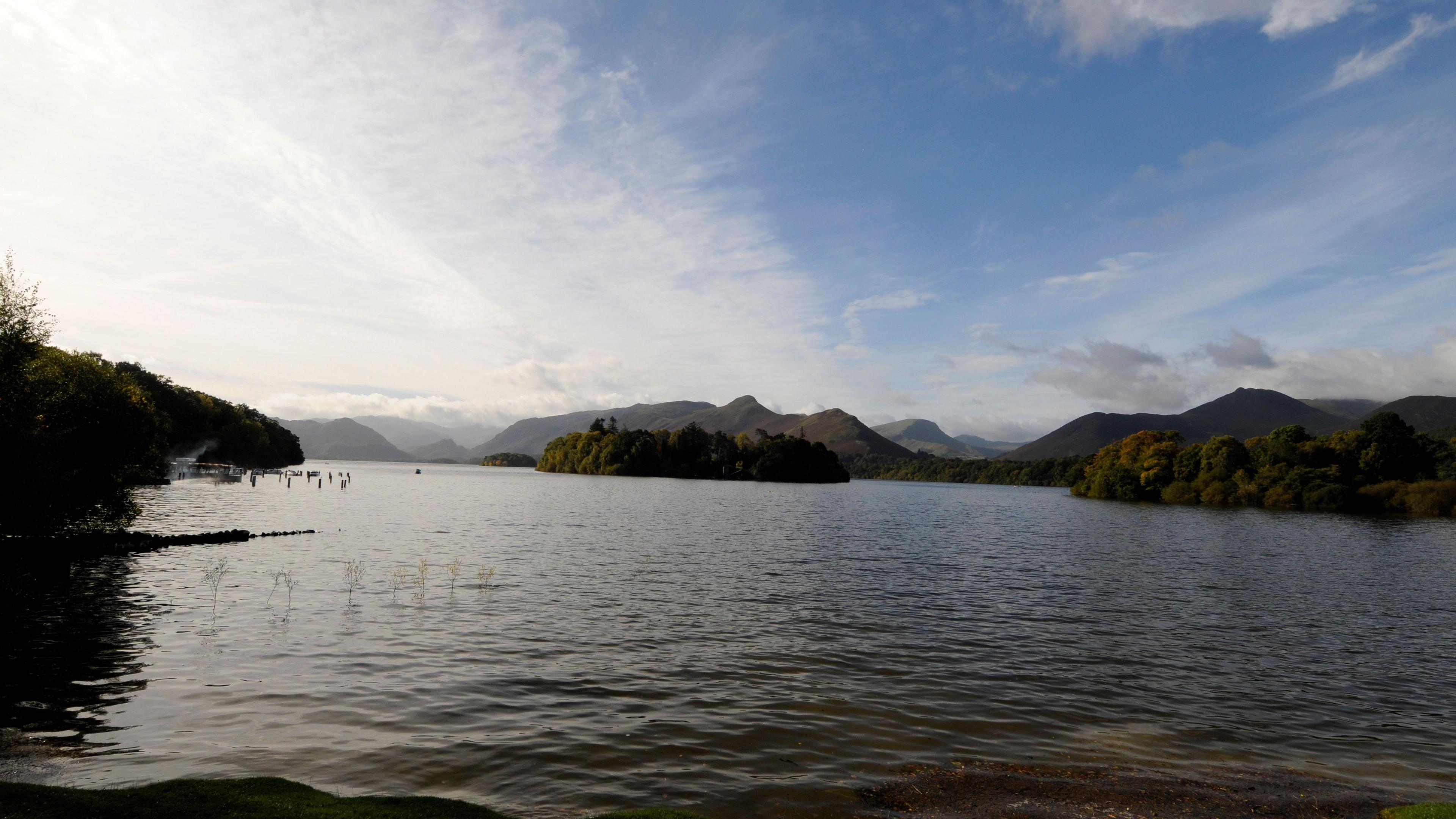 A large lake with fells in the background