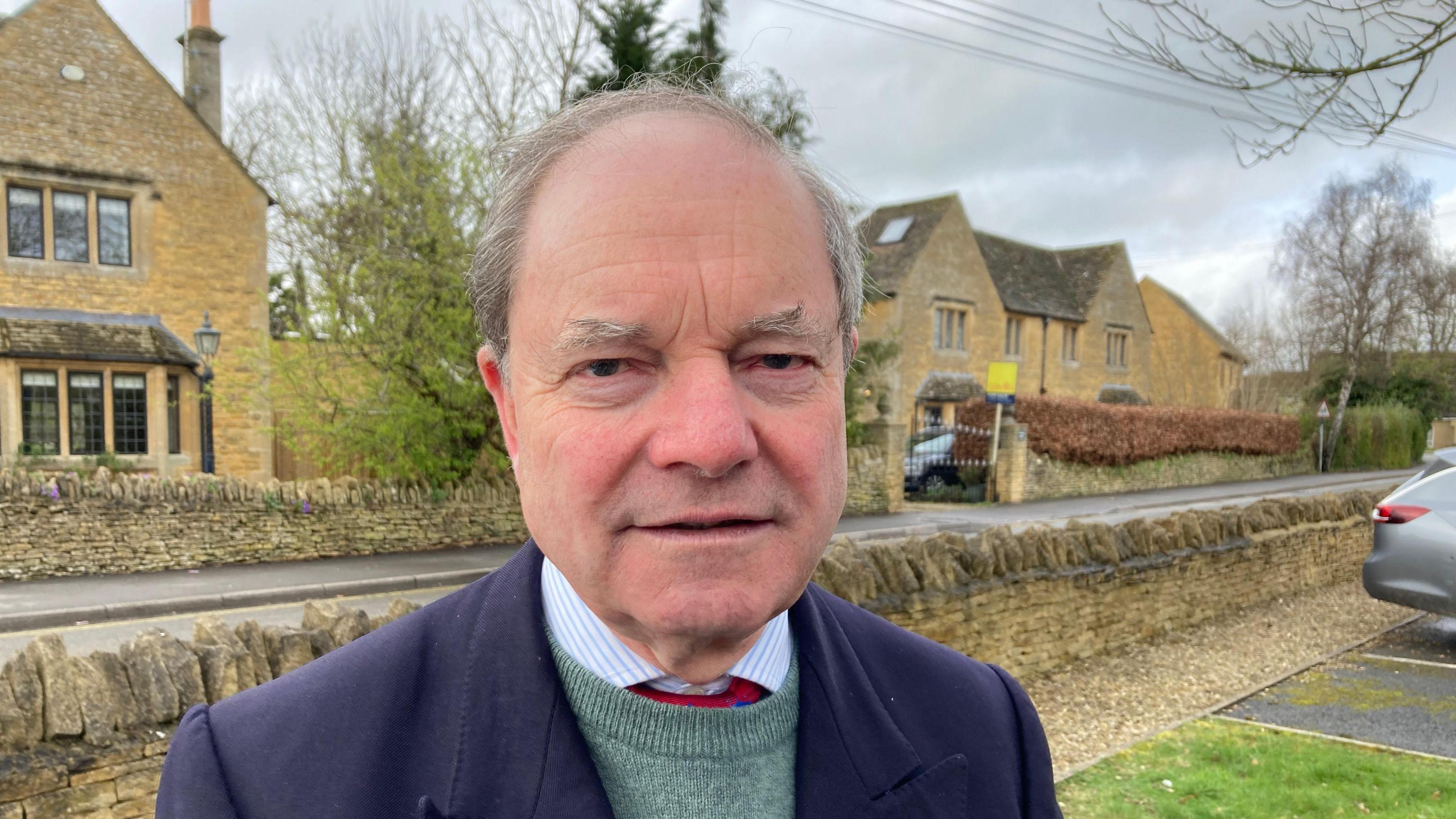 Sir Geoffrey Clifton-Brown in Bourton on the Water. He has grey hair and is wearing a blue suit jacket.