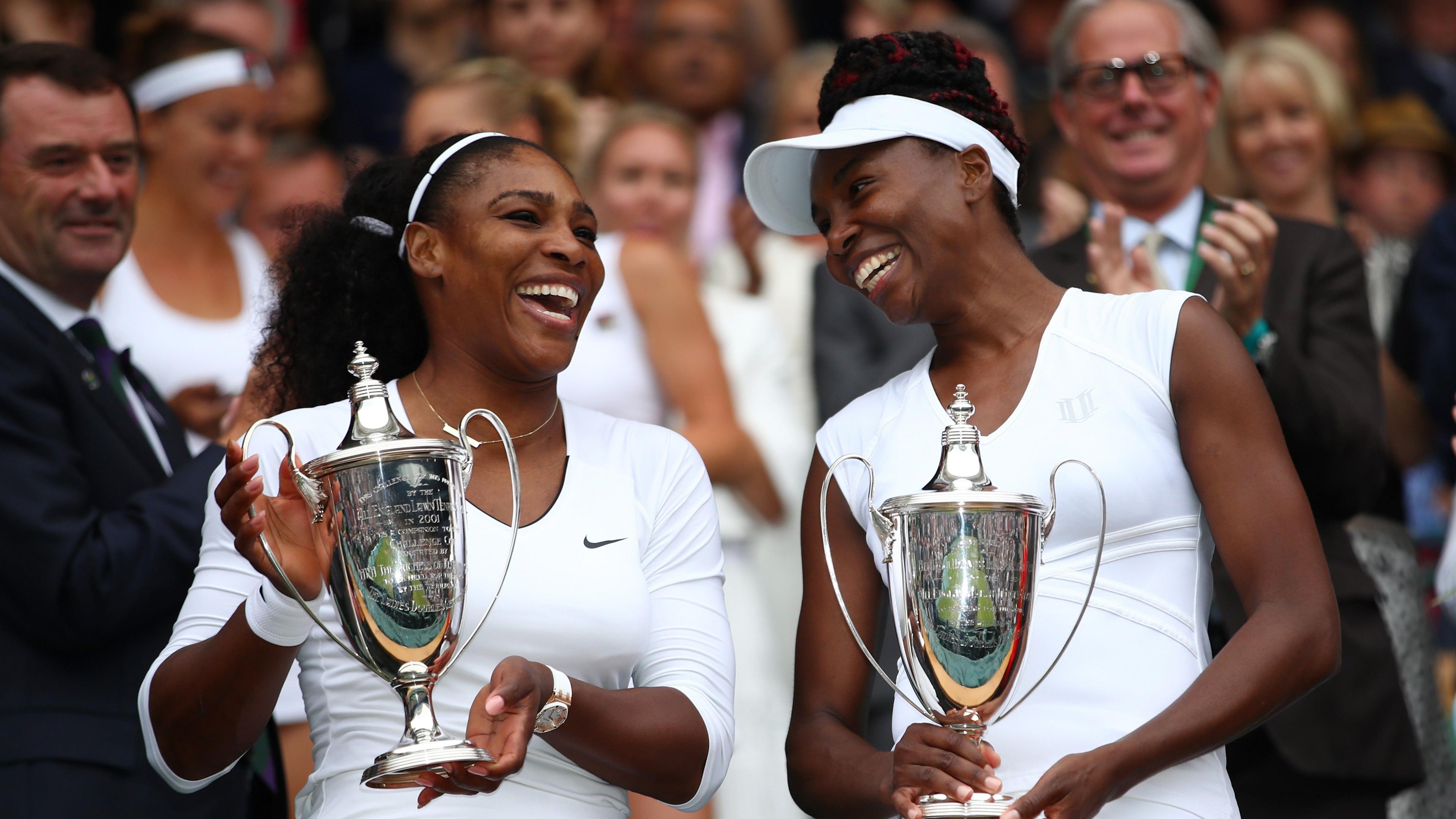 Serena and Venus Williams with the Wimbledon doubles trophies in 2016