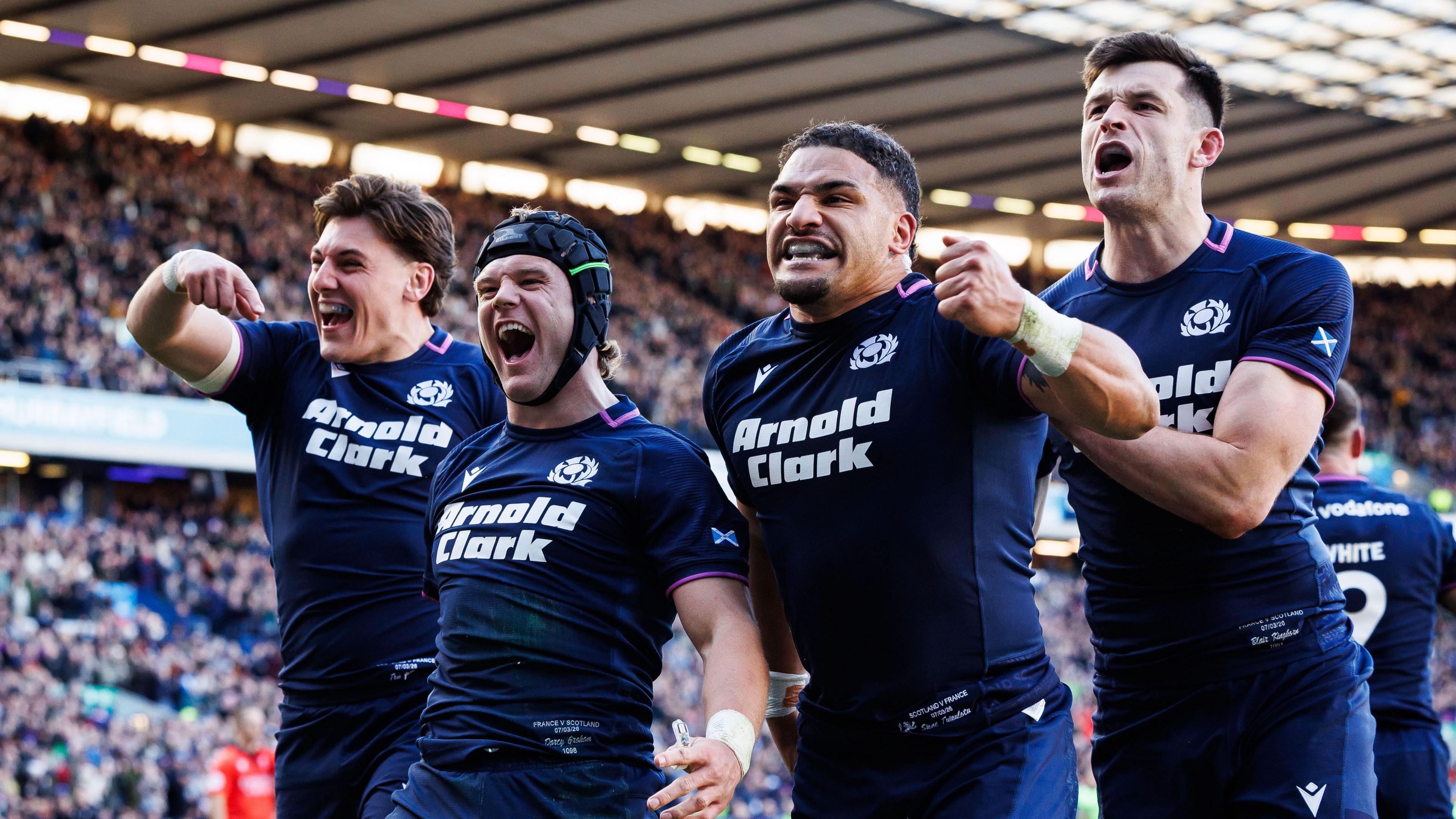 Scotland players celebrate after scoring a try