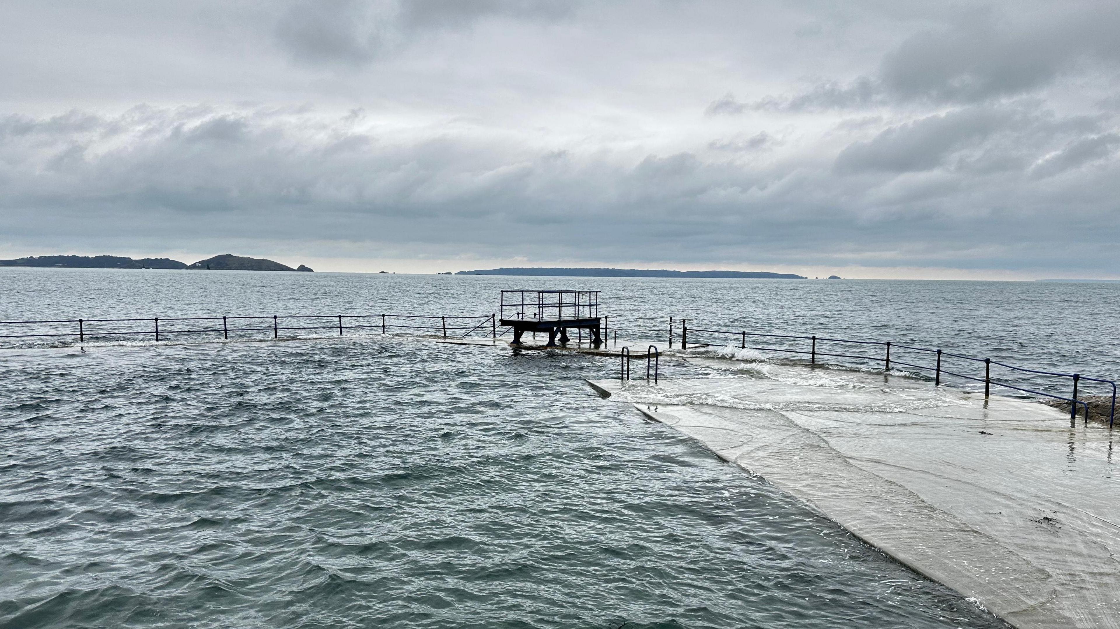 A picture at high tide of the Ladies bathing pools. You can see Herm and Sark in the horizon. 