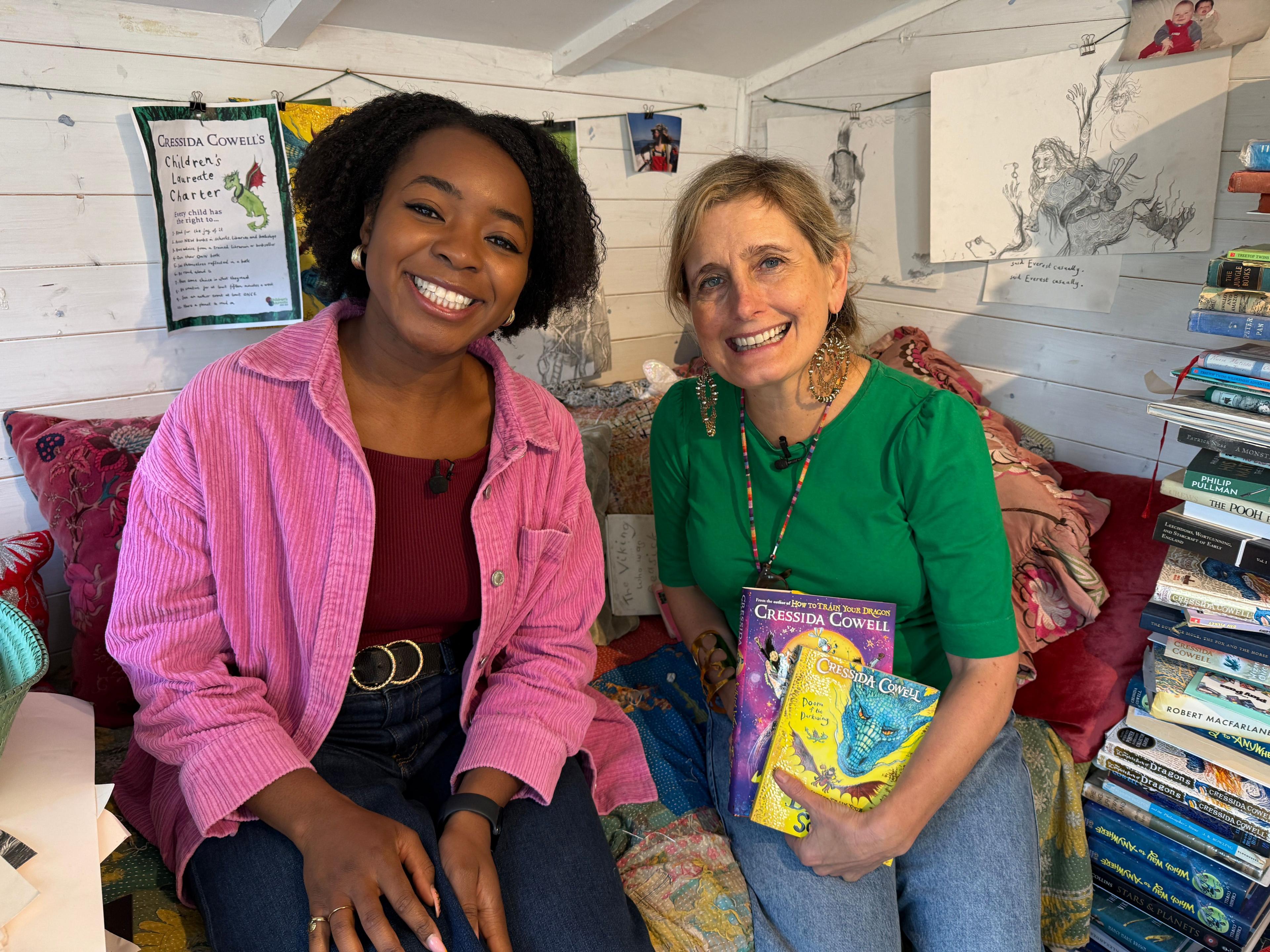 author-cressida-cowell-sitting-with-newsround-presenter-Emma-Louise-in-cressidas-writing-shed