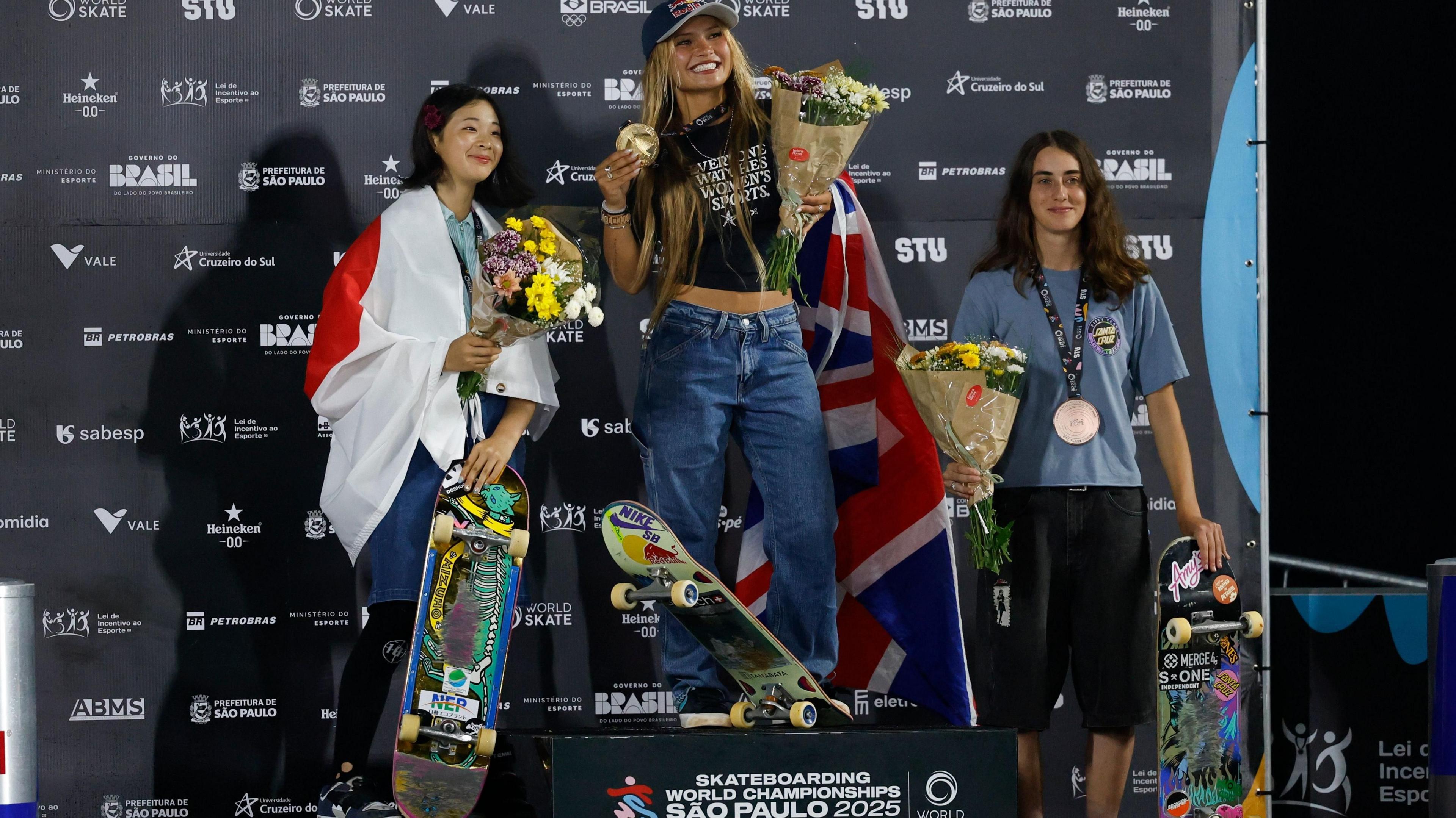 Second place Mizuho Hasegawa of Japan (left), first place Sky Brown of Britain (centre) and third place Minna Stess of the USA (right) pose on the podium during the award ceremony for the 'Park' category of the World Skateboarding Championships.
