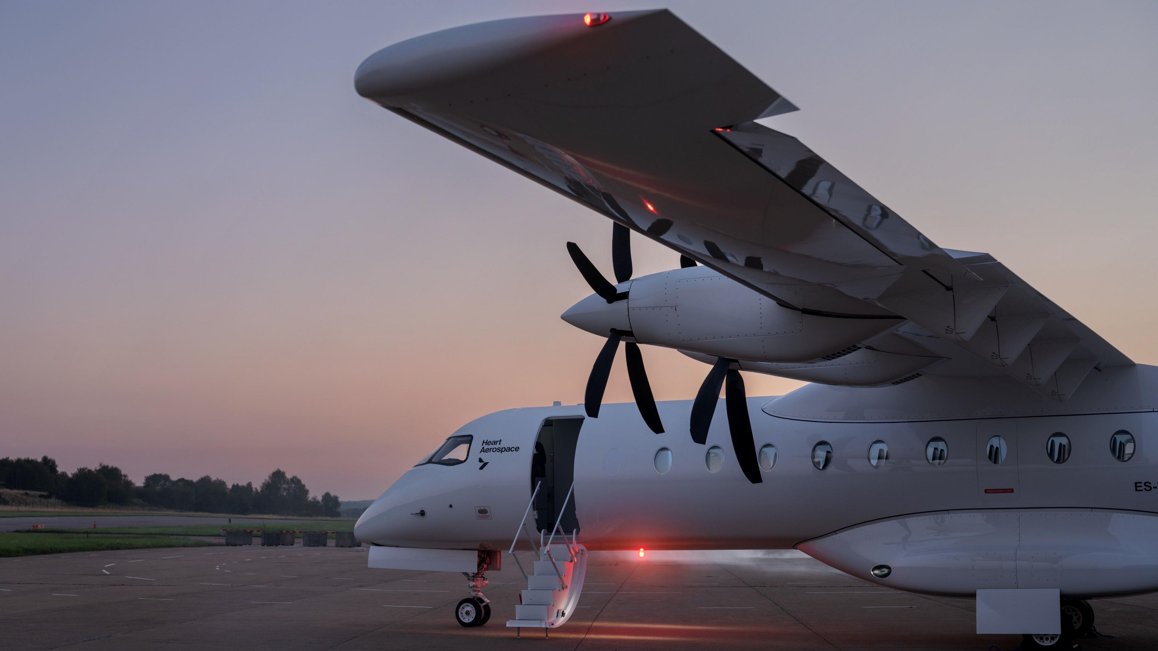 Heart's X1 looks like a large private jet. Visible are two propellers on the wing and a ladder leads up to the cabin door. 