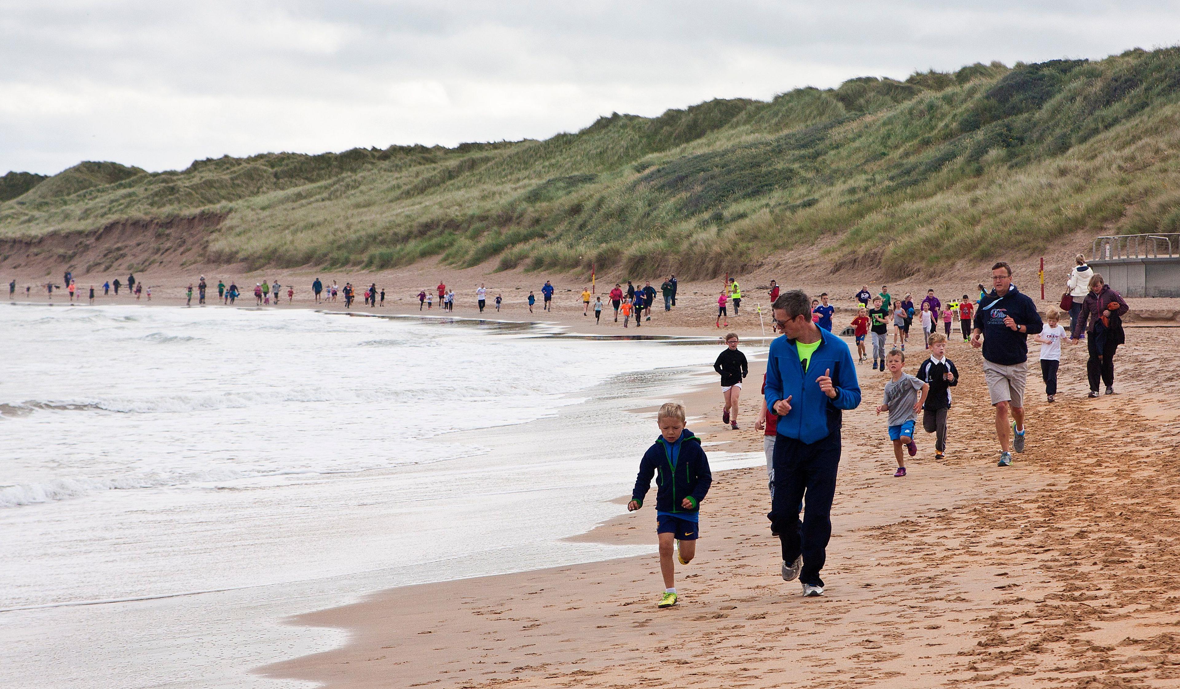 People on a beach Parkrun in 2015