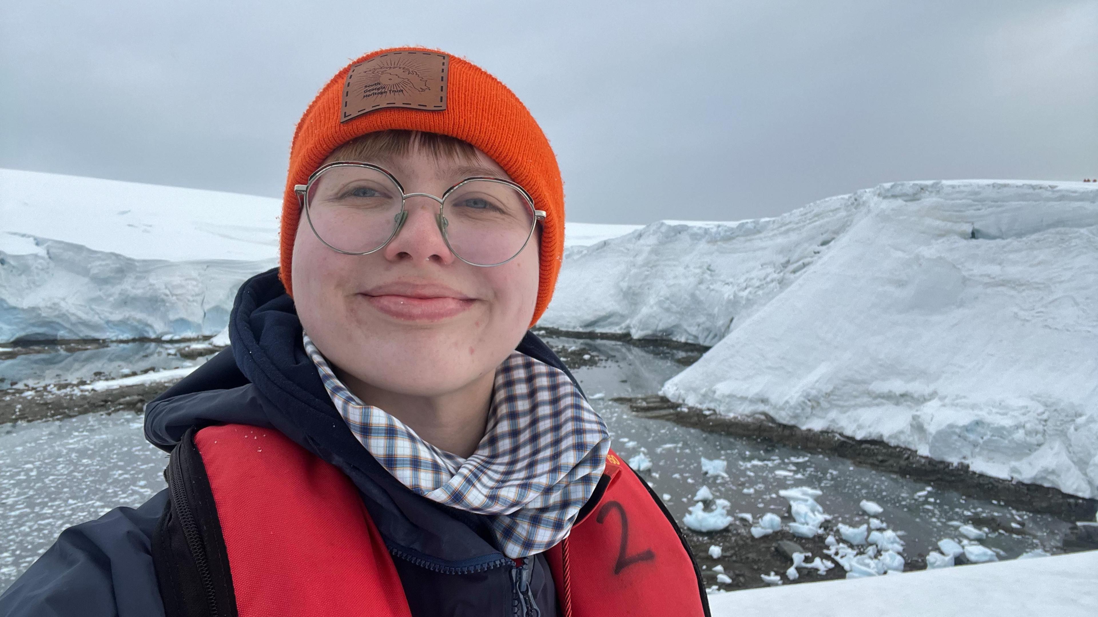 A woman standing outside in Port Lockroy, Antarctica
