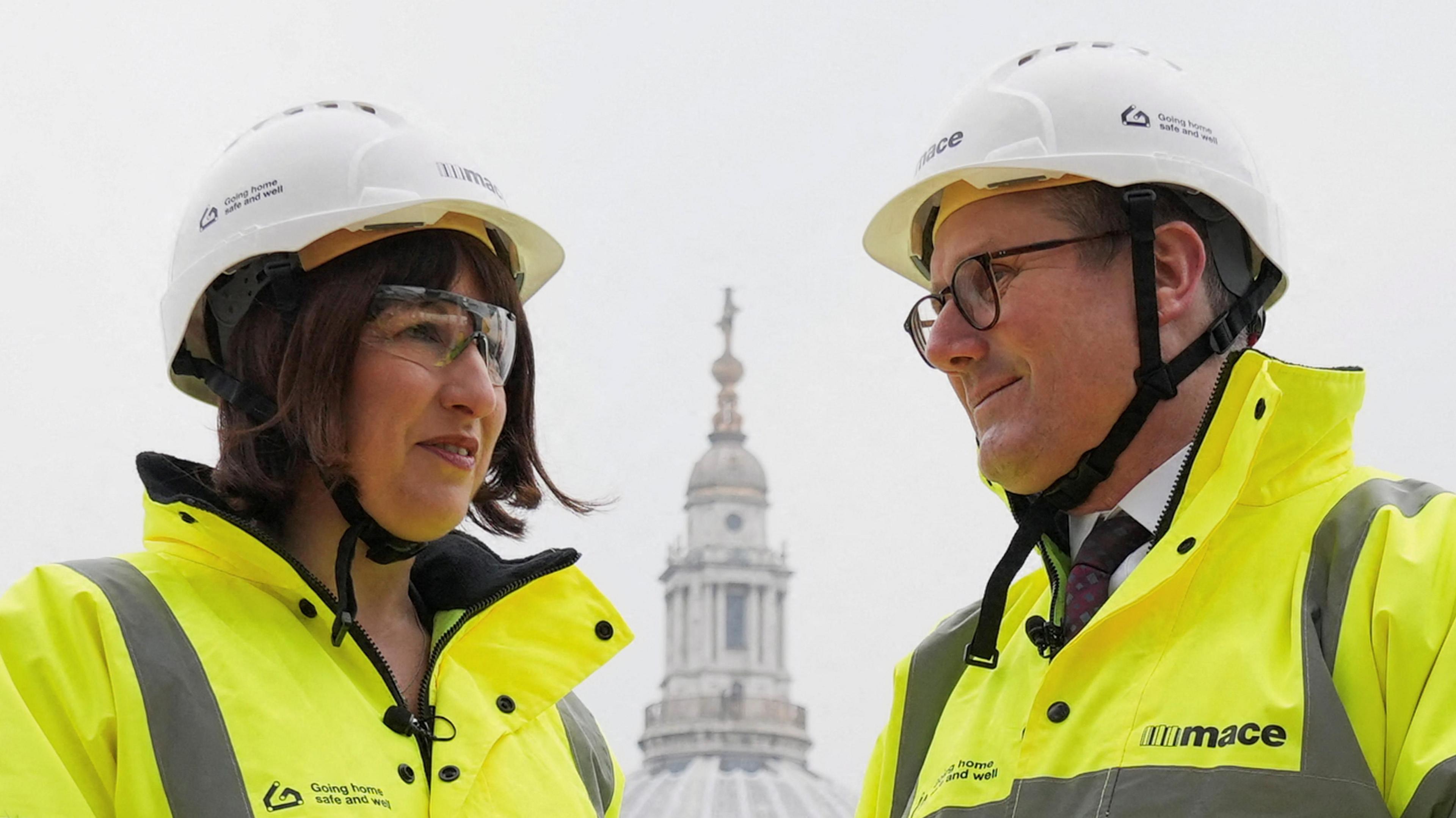 Rachel Reeves and Keir Starmer visiting a building site in London in March 2024, wearing hard hats and high-vis jackets. Reeves is wearing protective glasses too, while Starmer wears his own glasses.