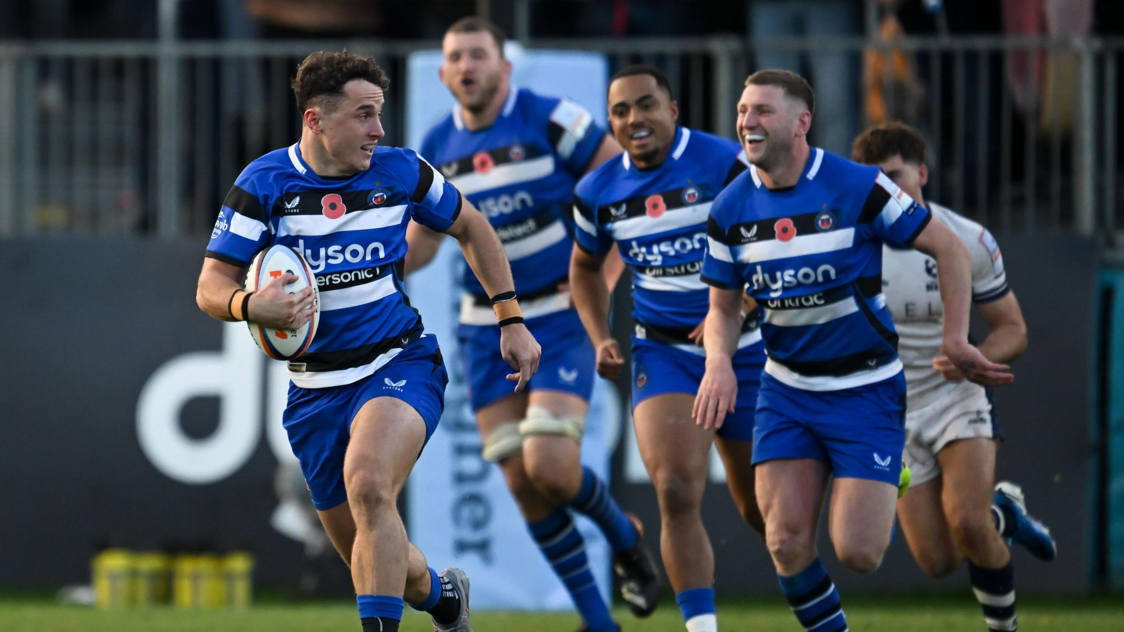 Henry Arundell (left) runs with the ball as team-mates Max Ojomoh and Finn Russell run behind