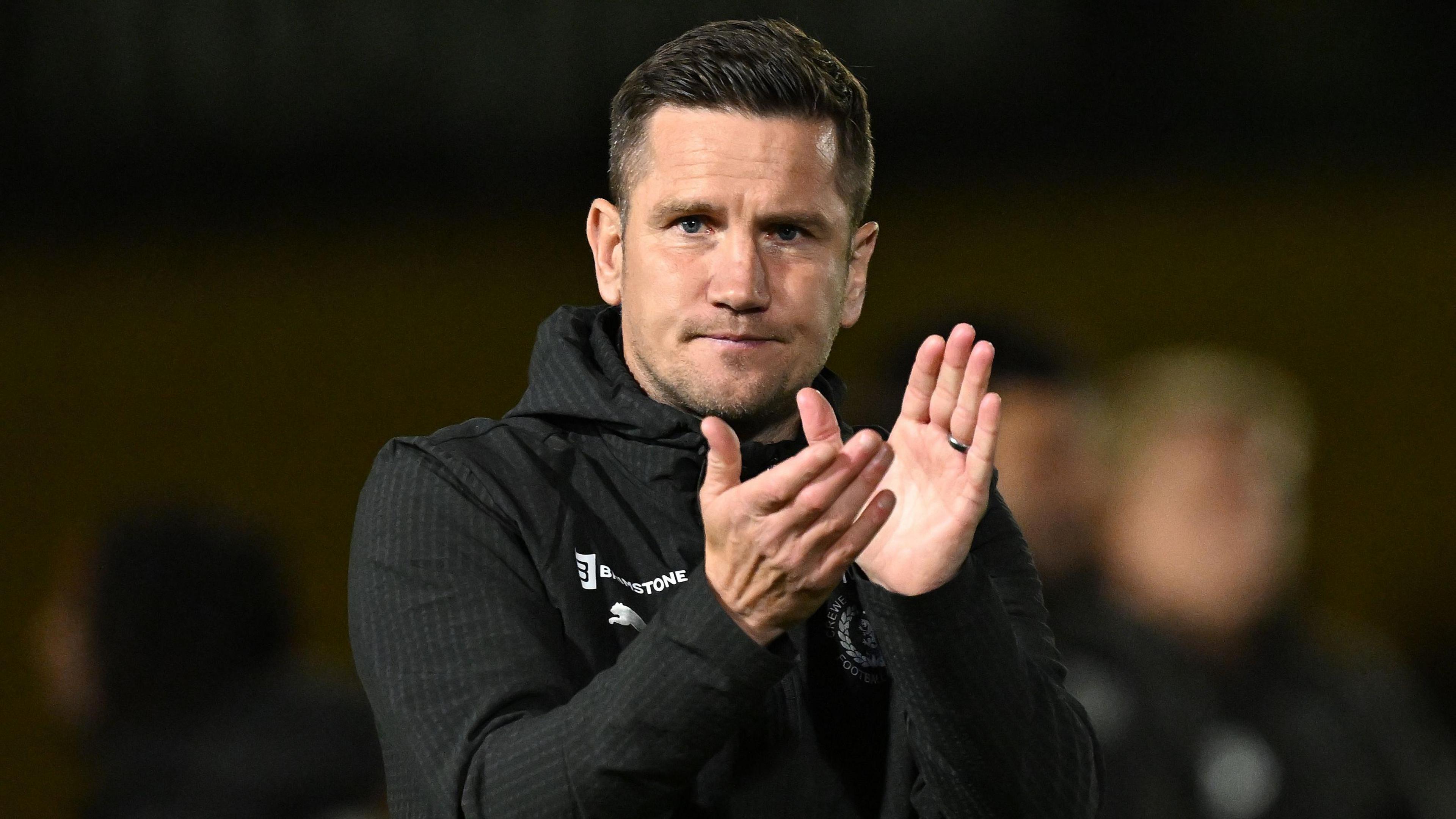 Lee Bell claps the crowd after a game