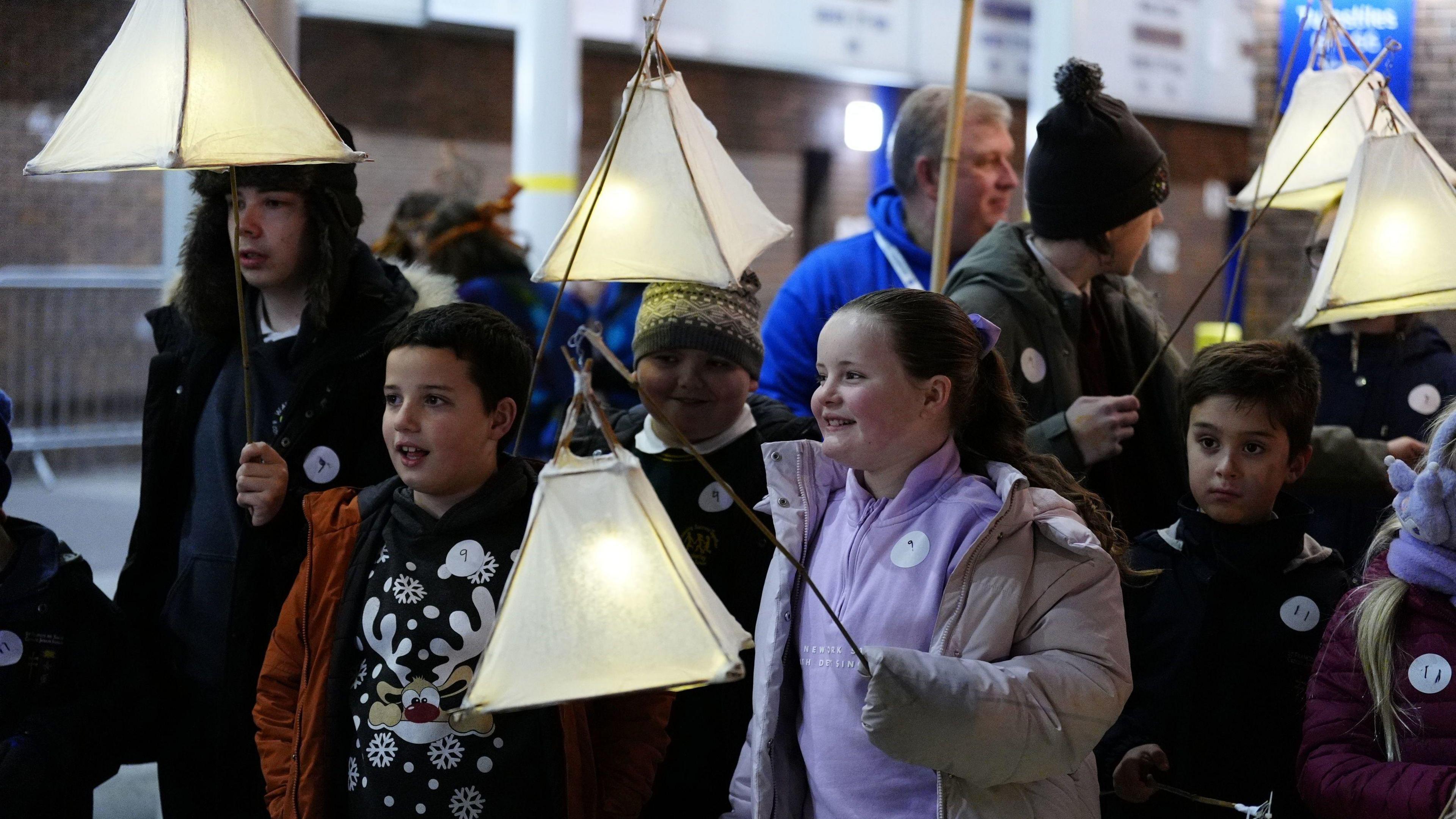 Five children holding lanterns 