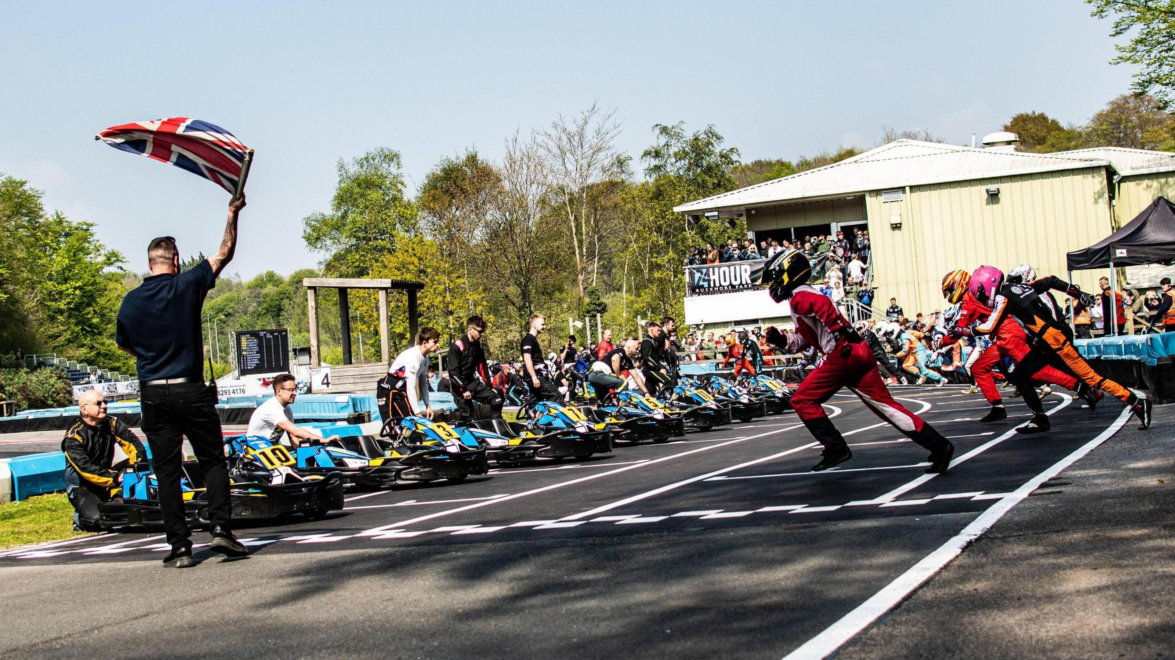 24 hour karting race competitors and pit crews prepare for an event on the track at Buckmore Park in Chatham