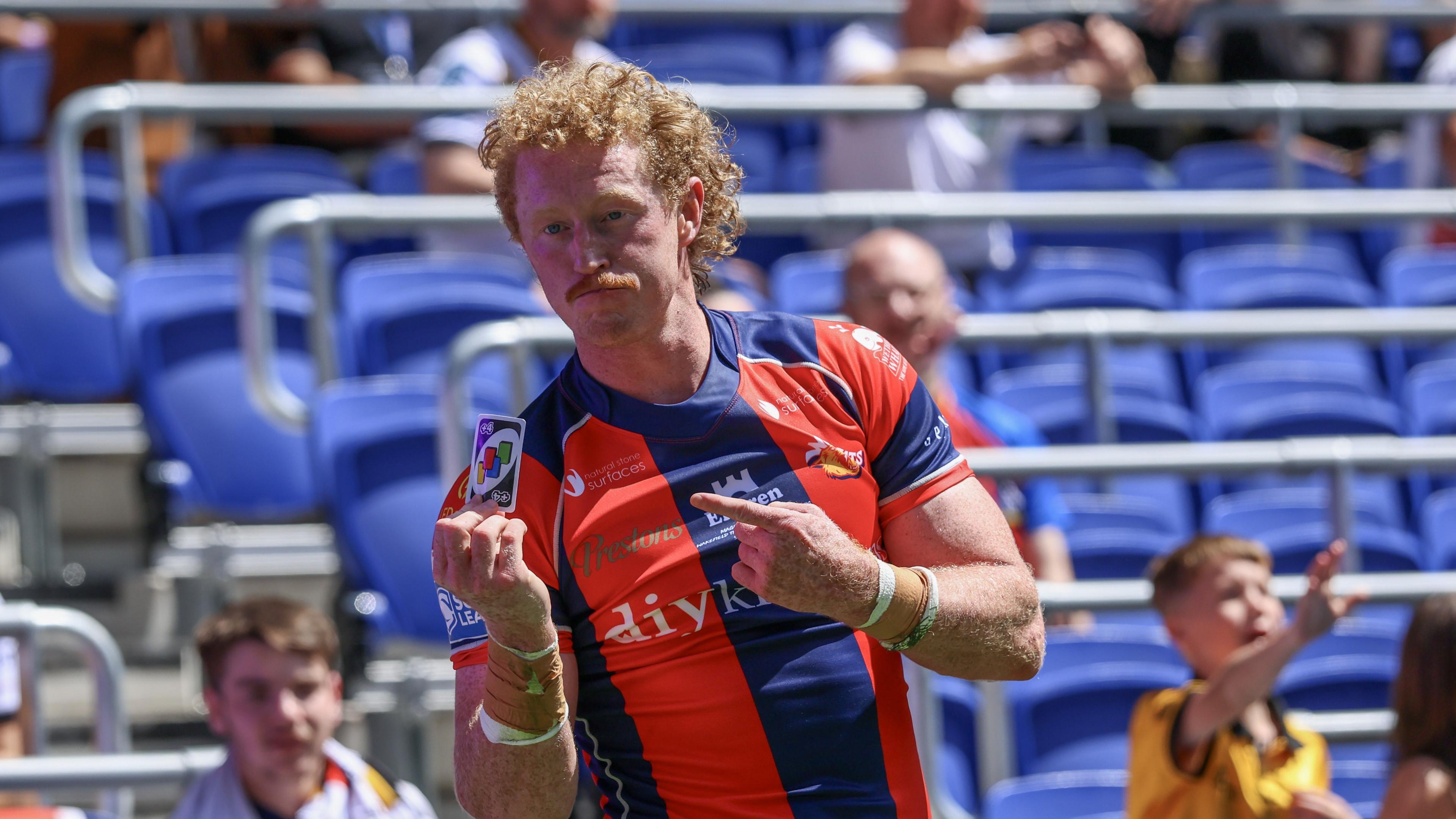 Lachlan Walmsley shows off a Uno +4 card to celebrate his brilliant try for Wakefield against Castleford