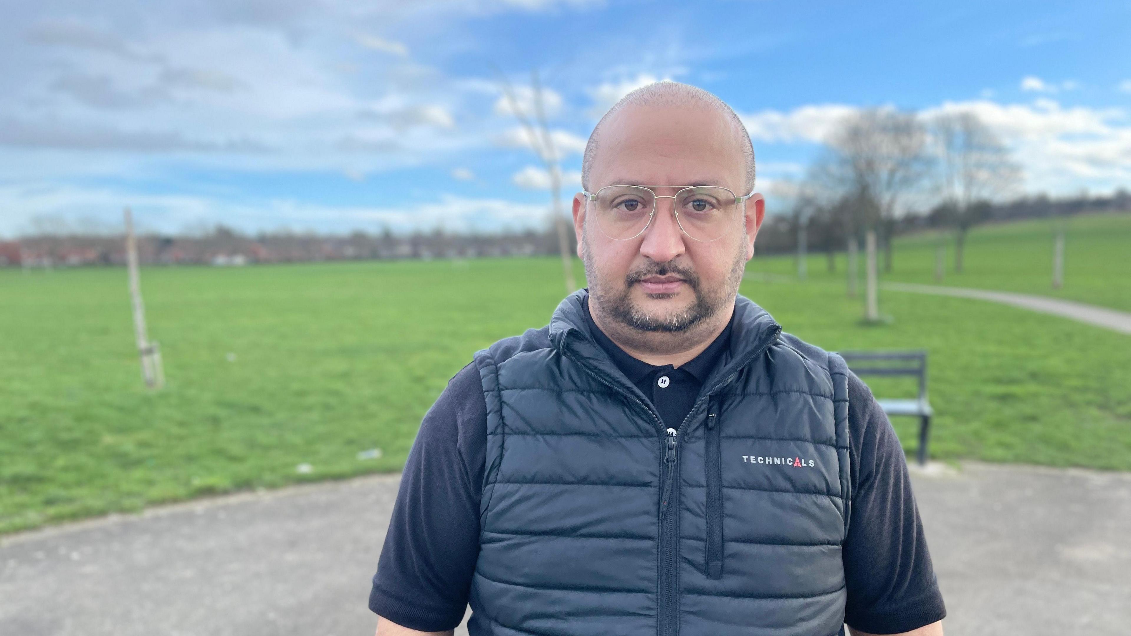 Zaheer Ahmed facing camera with park in the background